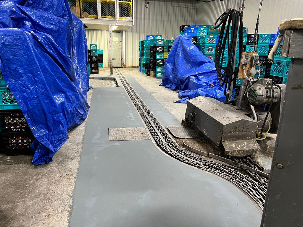 Food and beverage facility floor during repair with embedded production track system