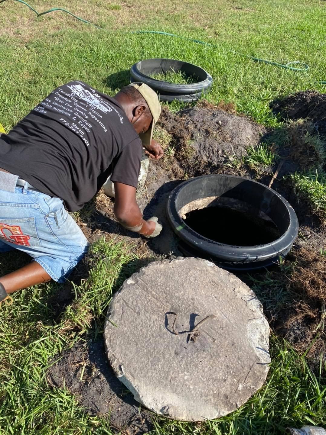 Technician servicing septic system access point