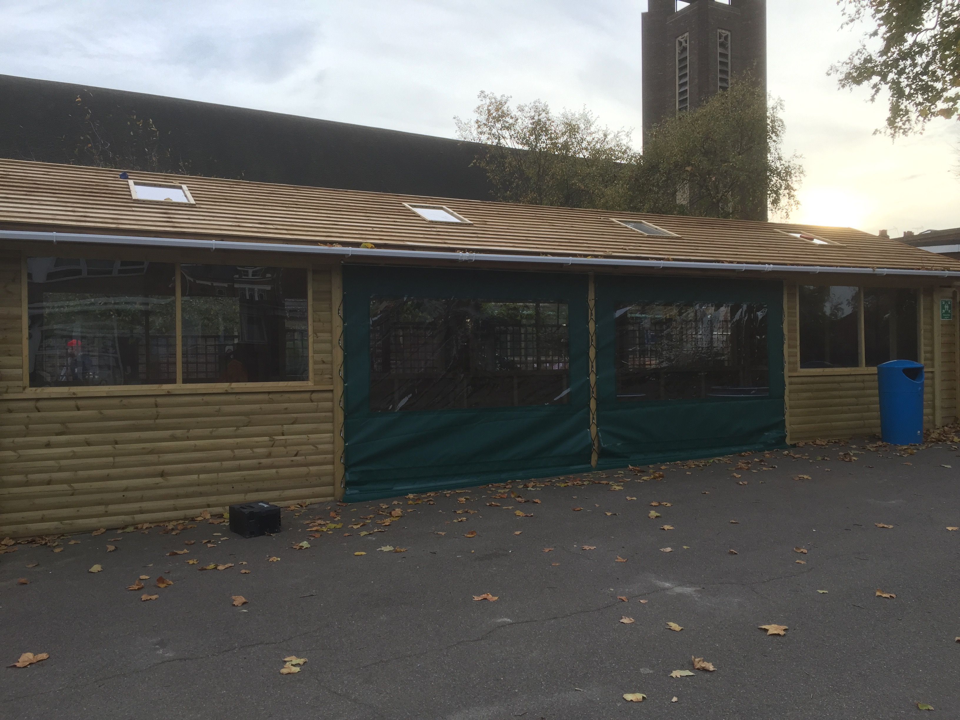 Enclosed outdoor classroom with curtains and windows