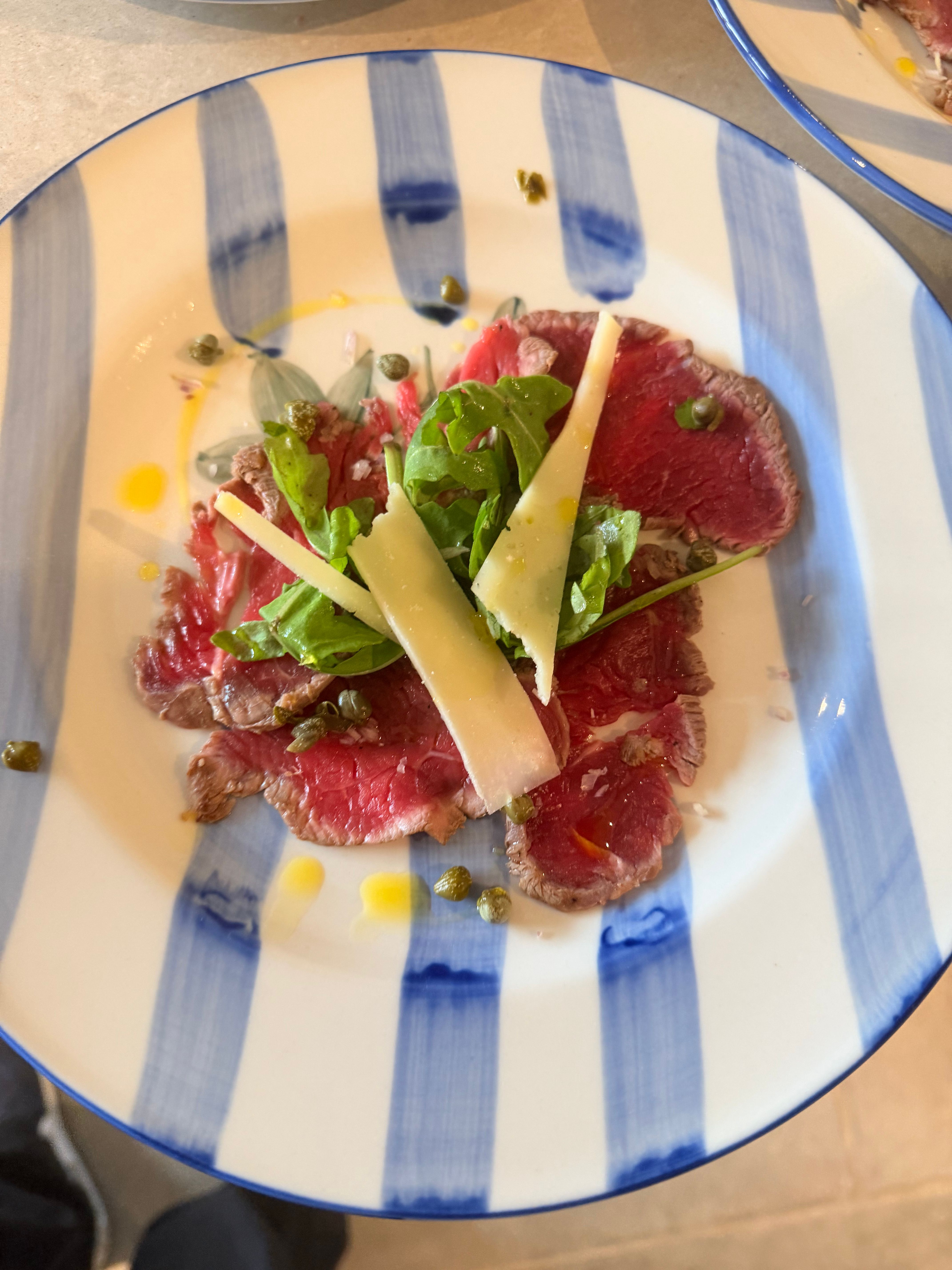 Beef carpaccio with rocket, parmesan and capers