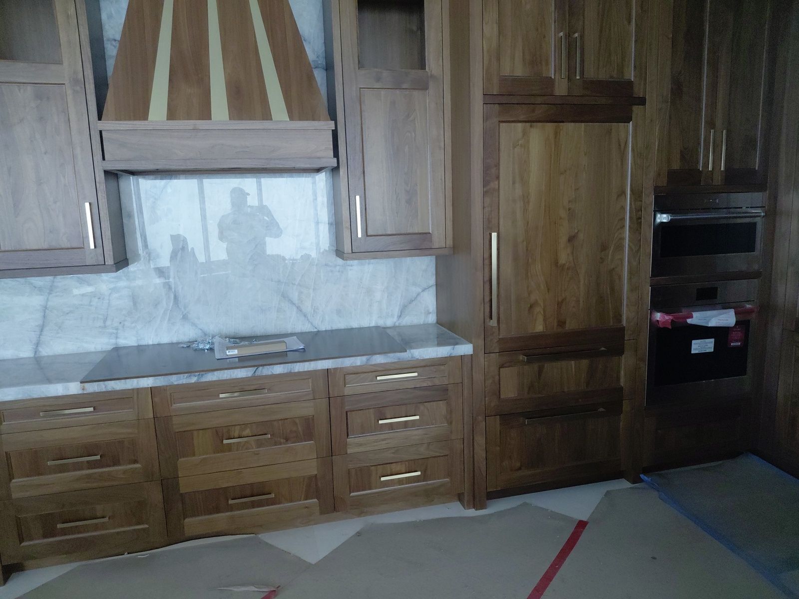 Kitchen renovation with new cabinetry and protected floors