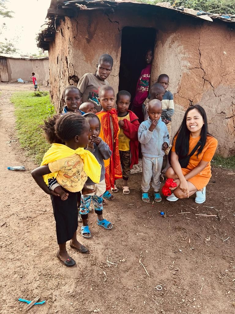 Pinkelle Safaris community visit with local children in a Kenyan village