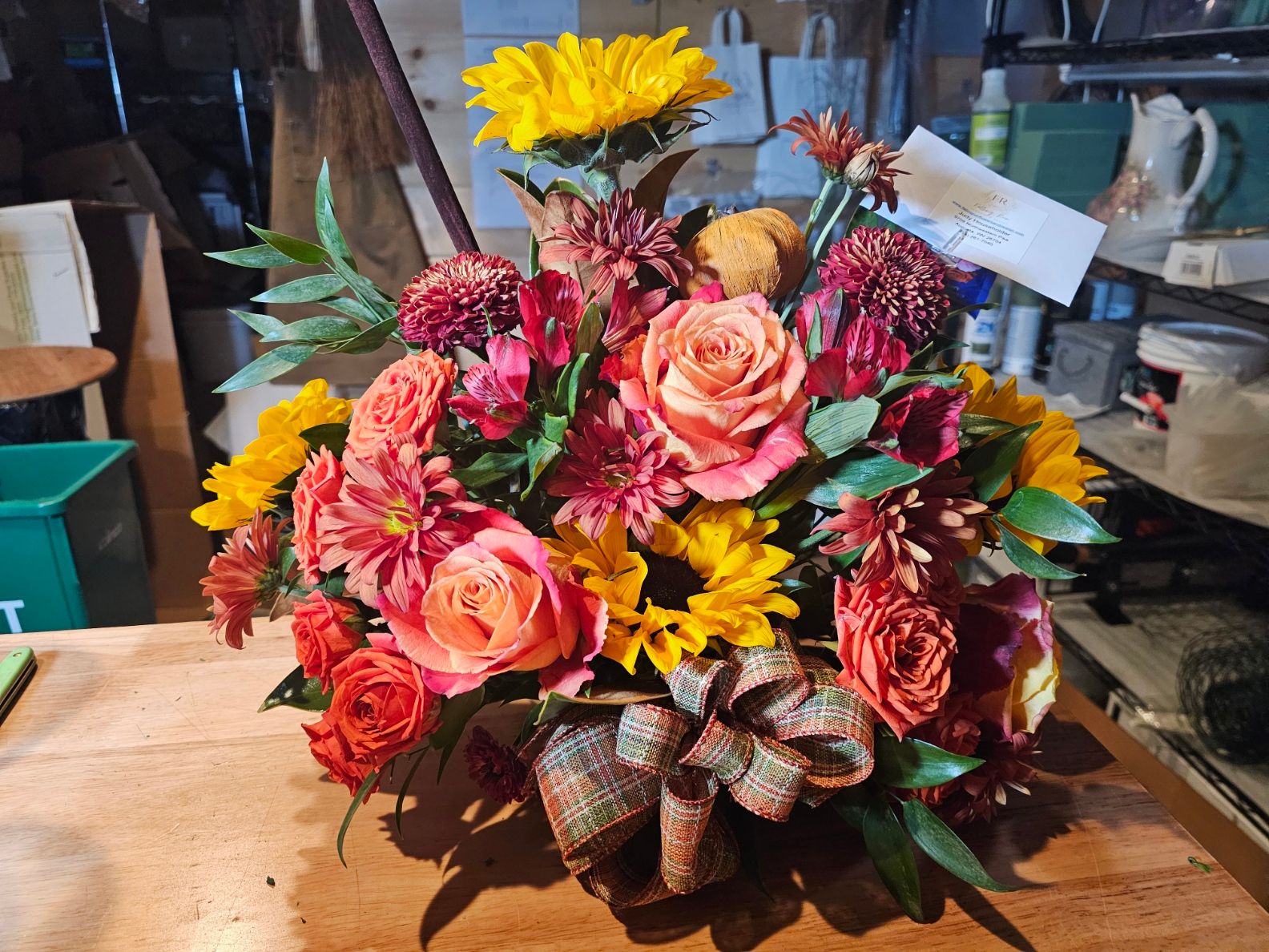 Sunflower arrangement with plaid bow and seasonal accents