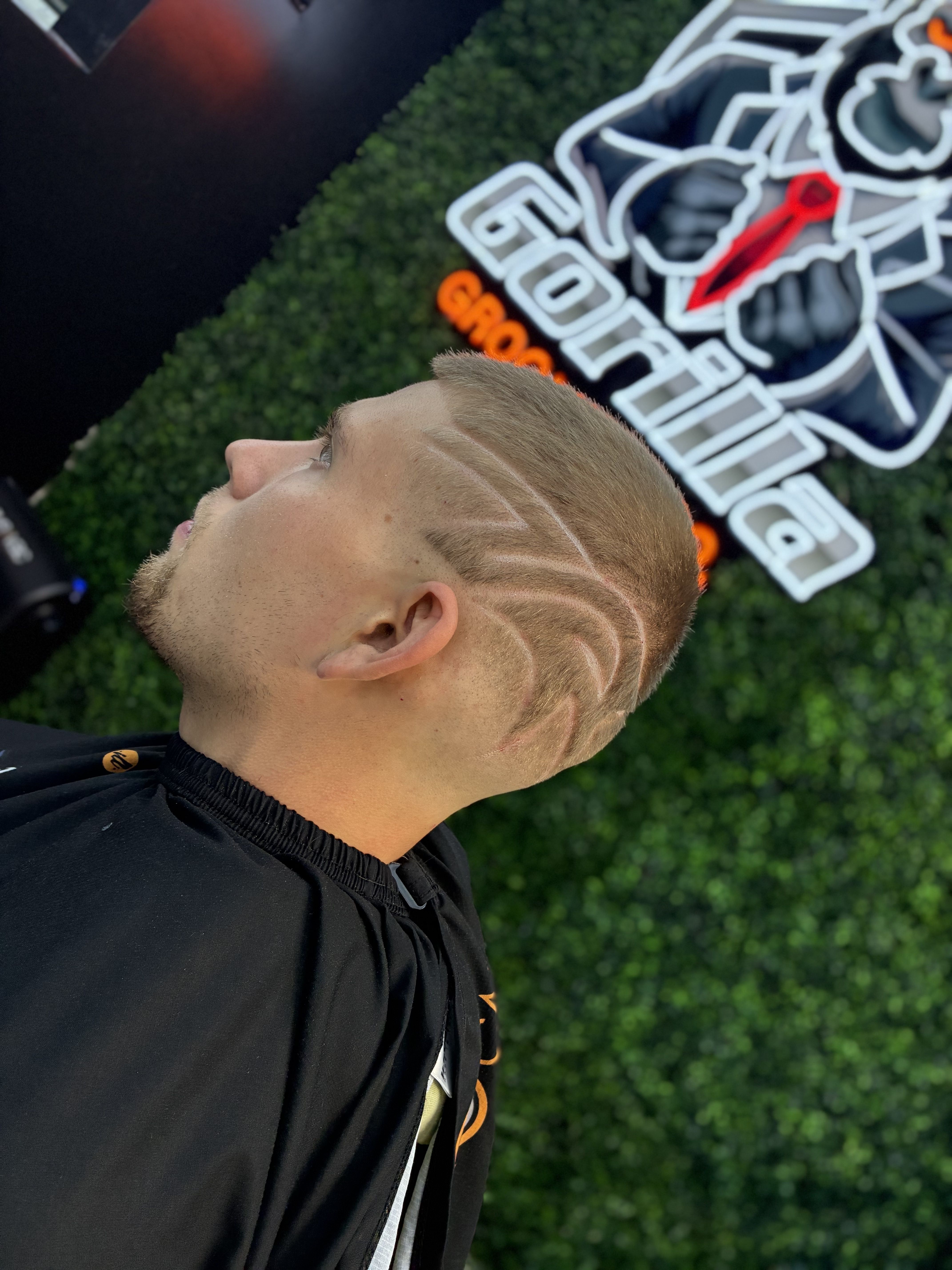 Precision fade with shaved line design — side profile