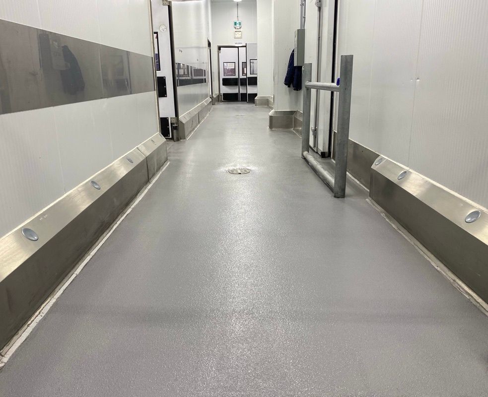 Food & beverage facility corridor with seamless gray epoxy flooring