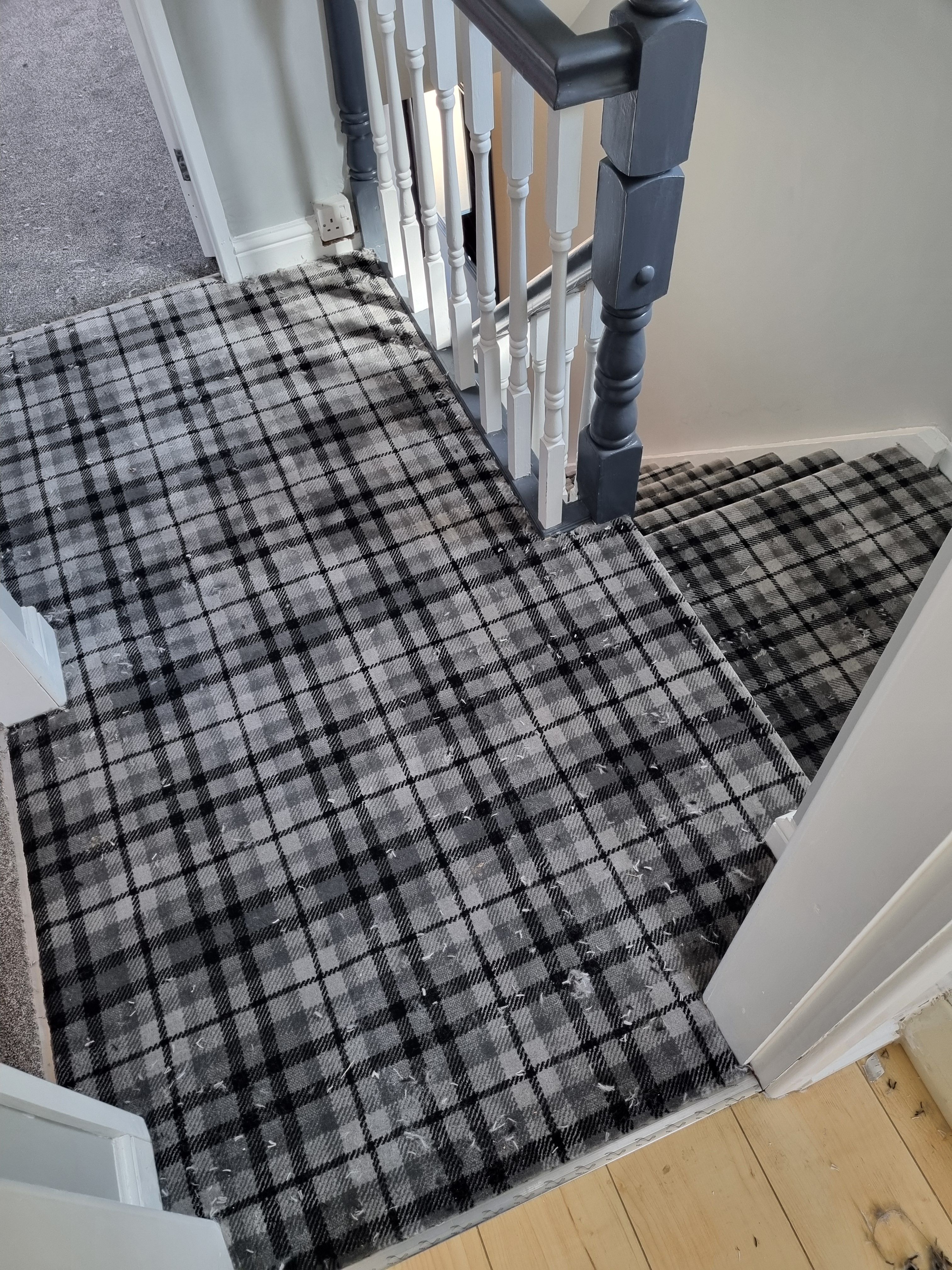 Plaid carpet on stairs and landing