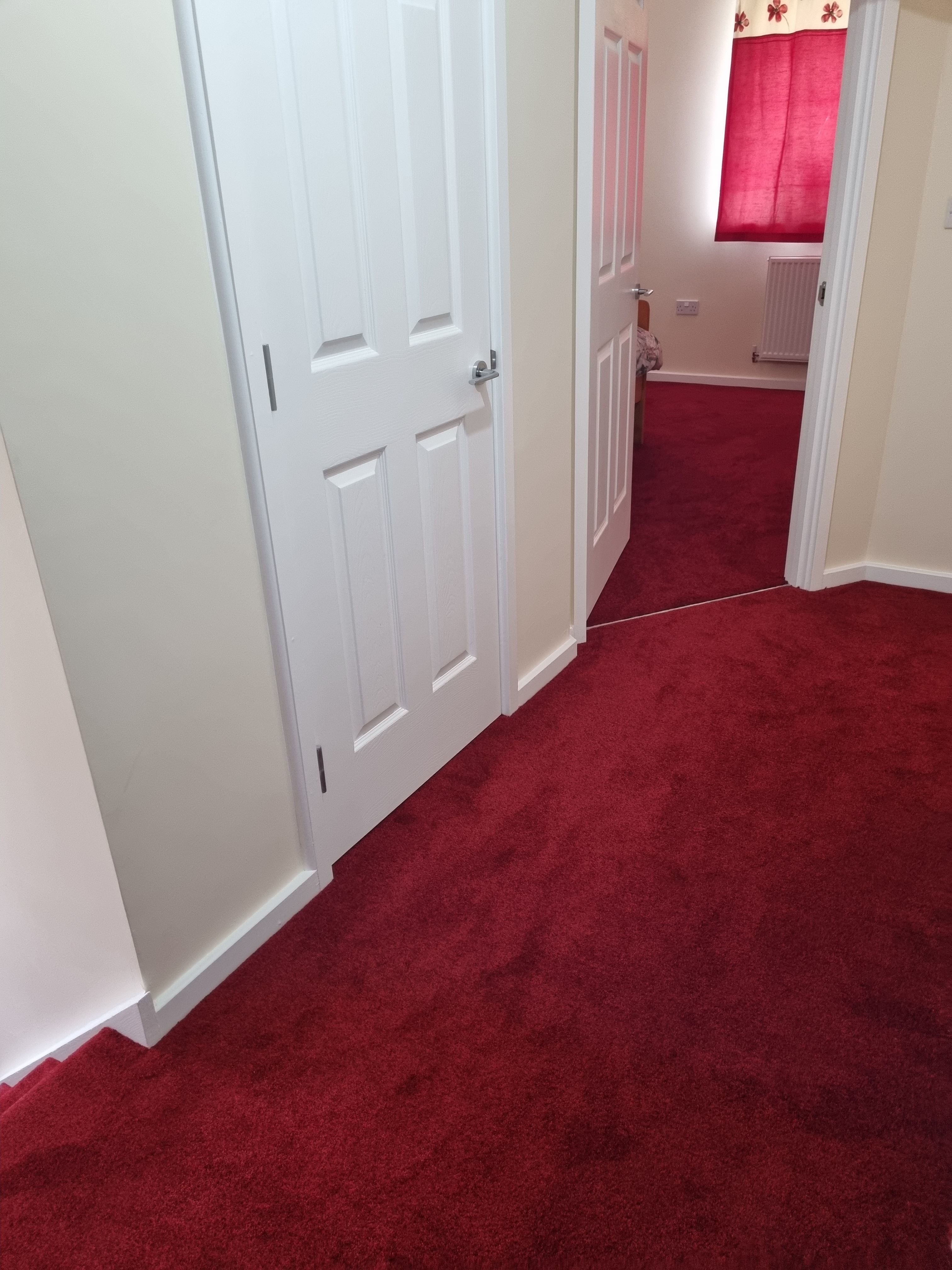 Deep red carpet fitted in hallway and bedrooms