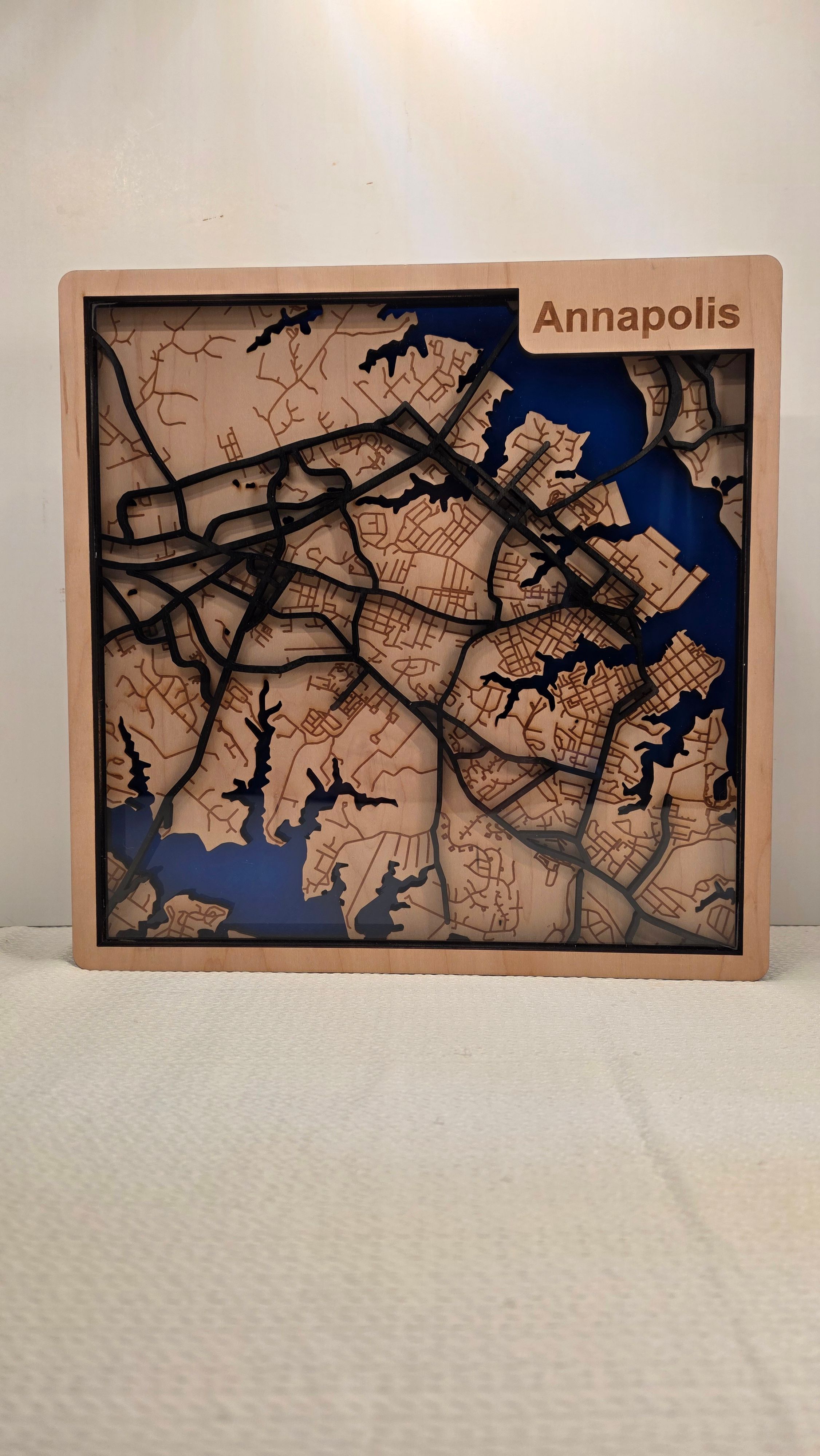 Layered wooden map of Annapolis Maryland with carved streets