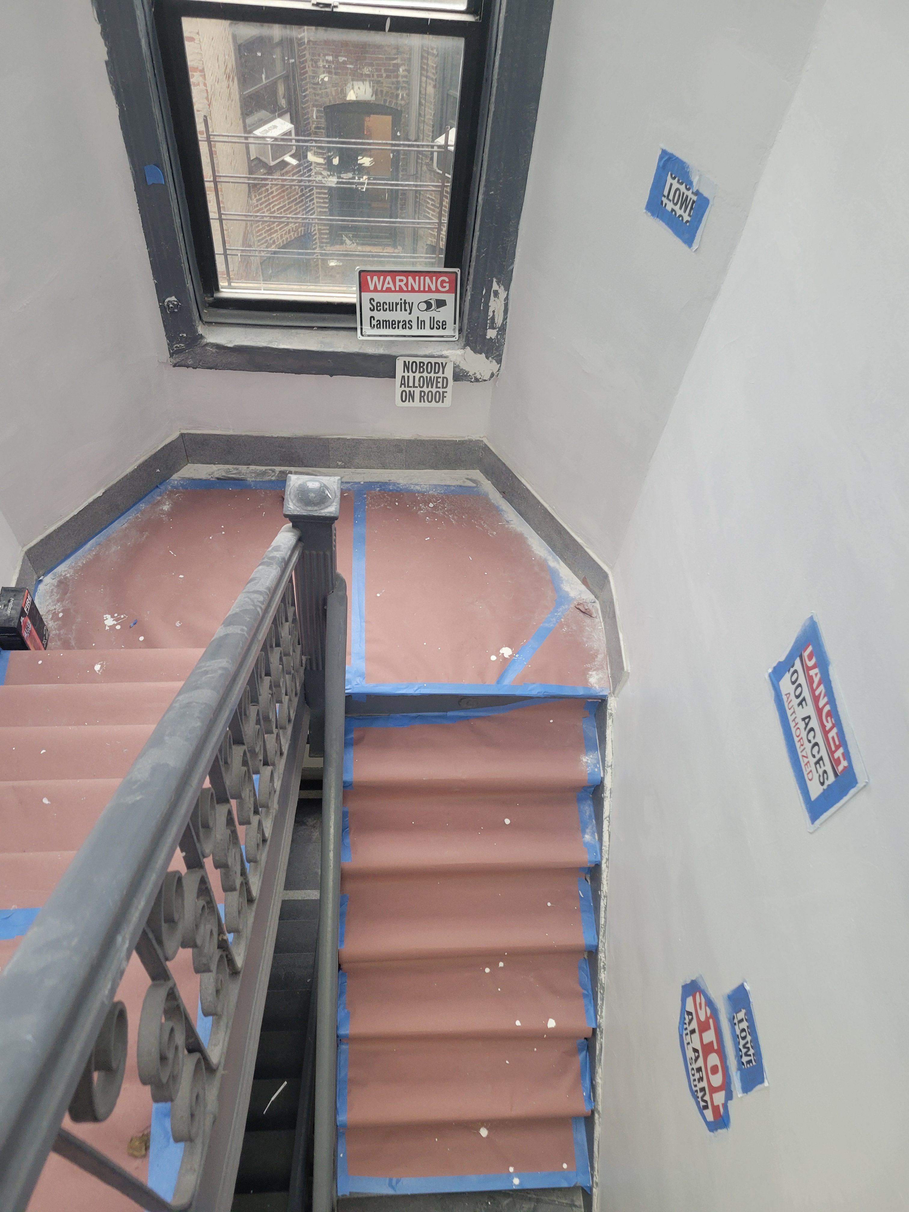 Finished roof landing repair - clean stairwell with protective paper on stairs