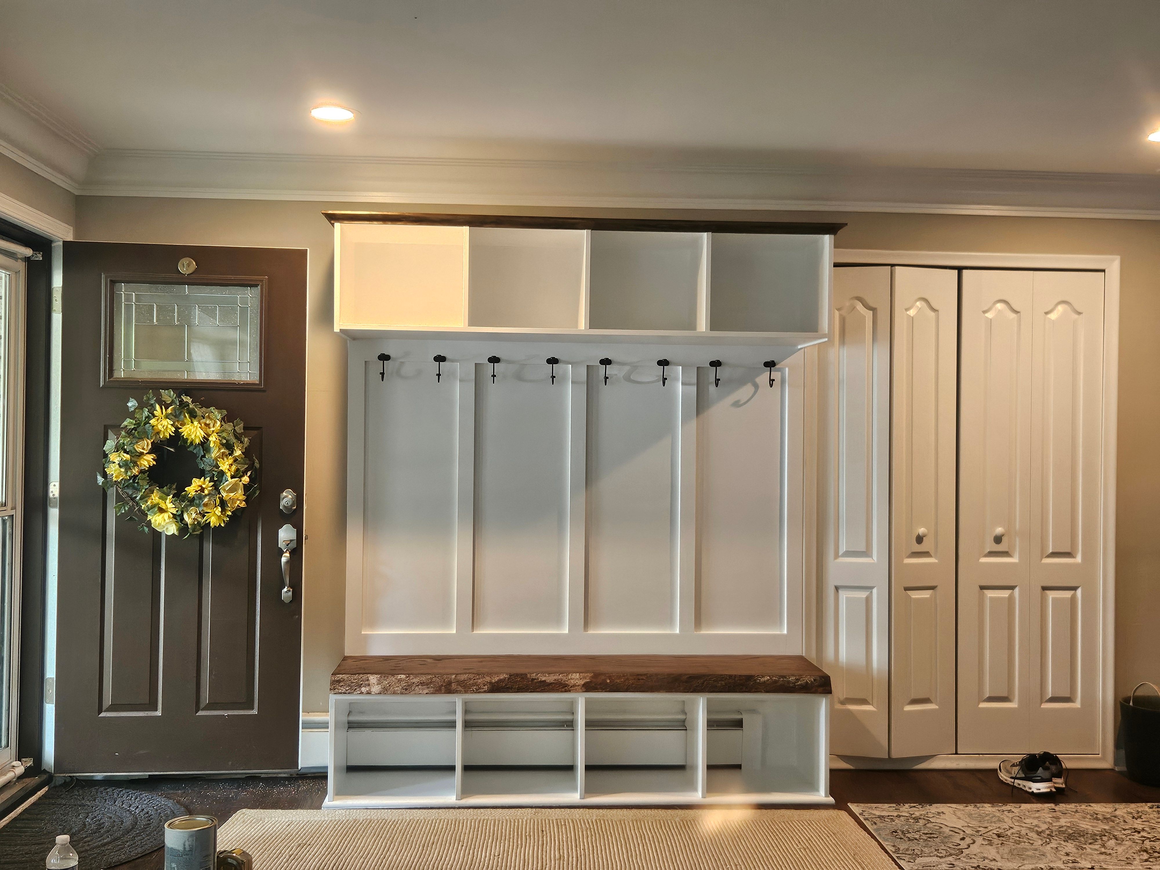 Custom entryway with built-in mudroom storage and bench