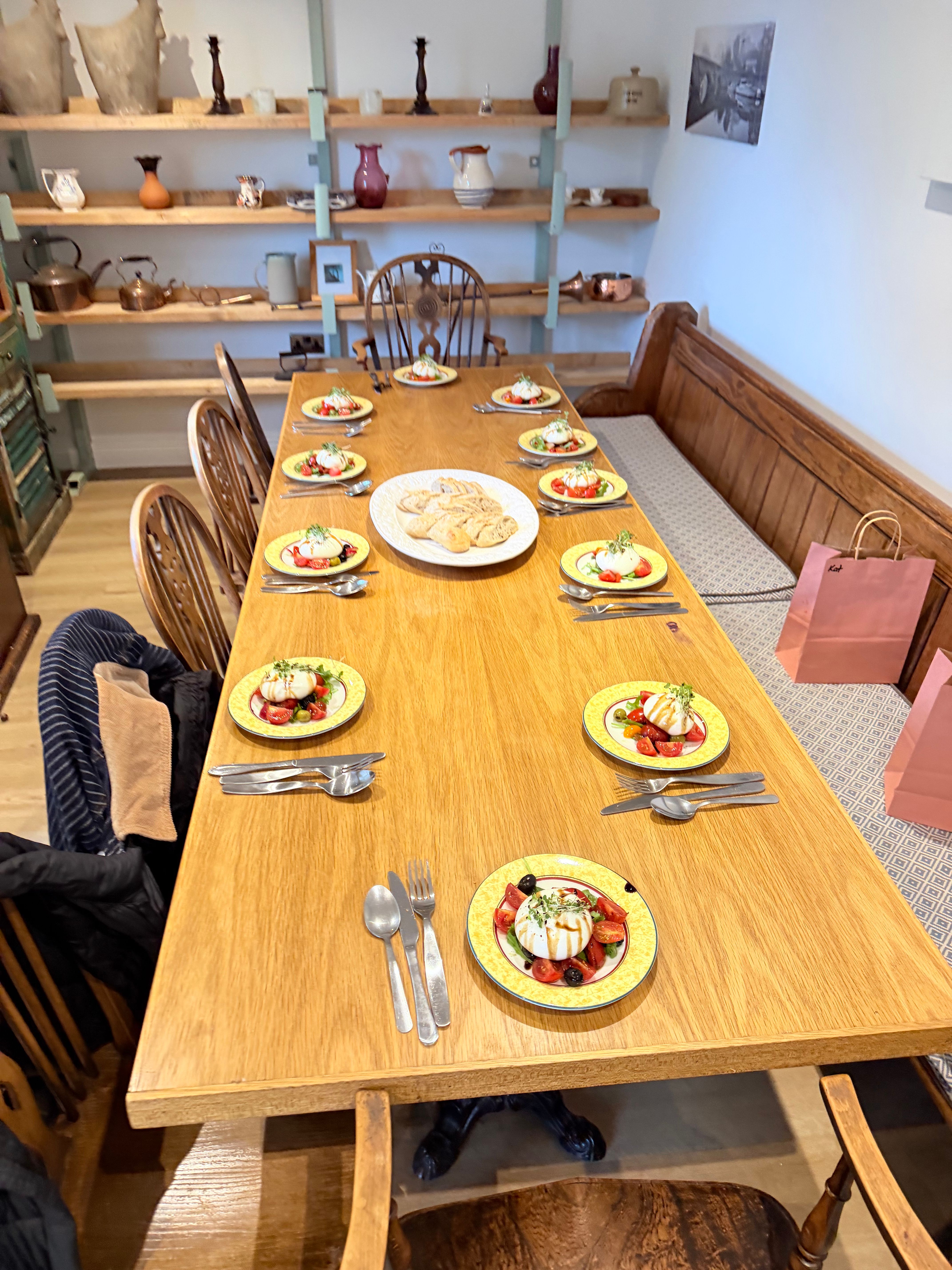Private dining table setting with plated starters and fresh bread