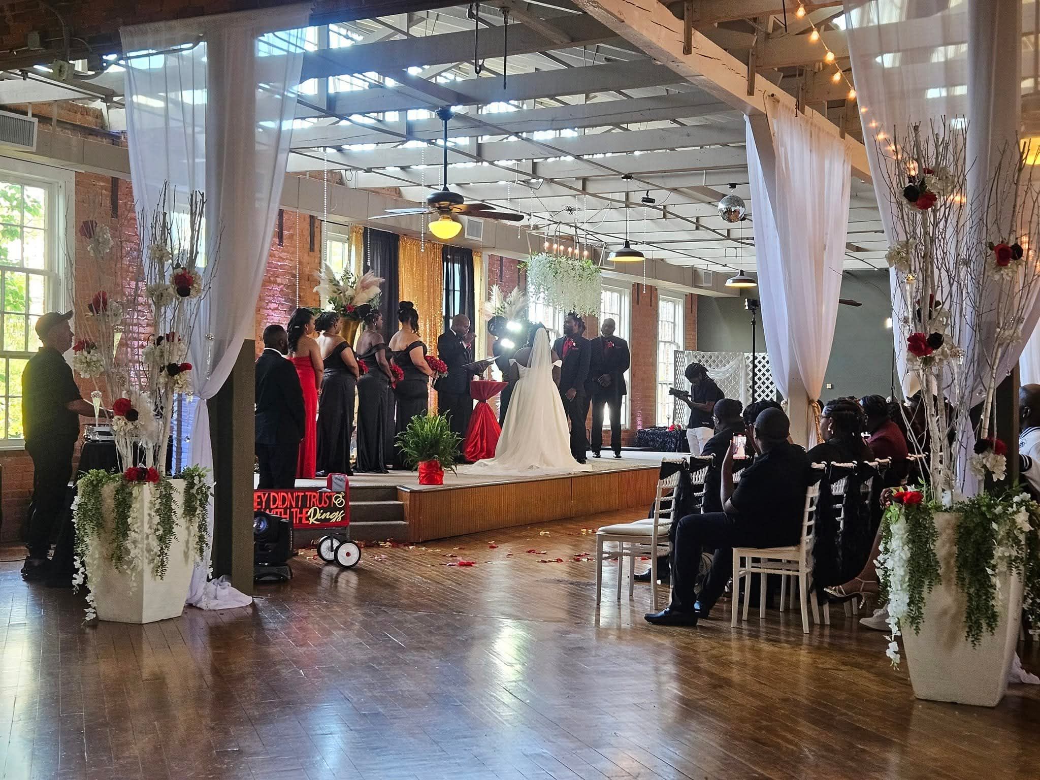 Wedding ceremony at Dove Down Event Center with bride, groom, and bridal party
