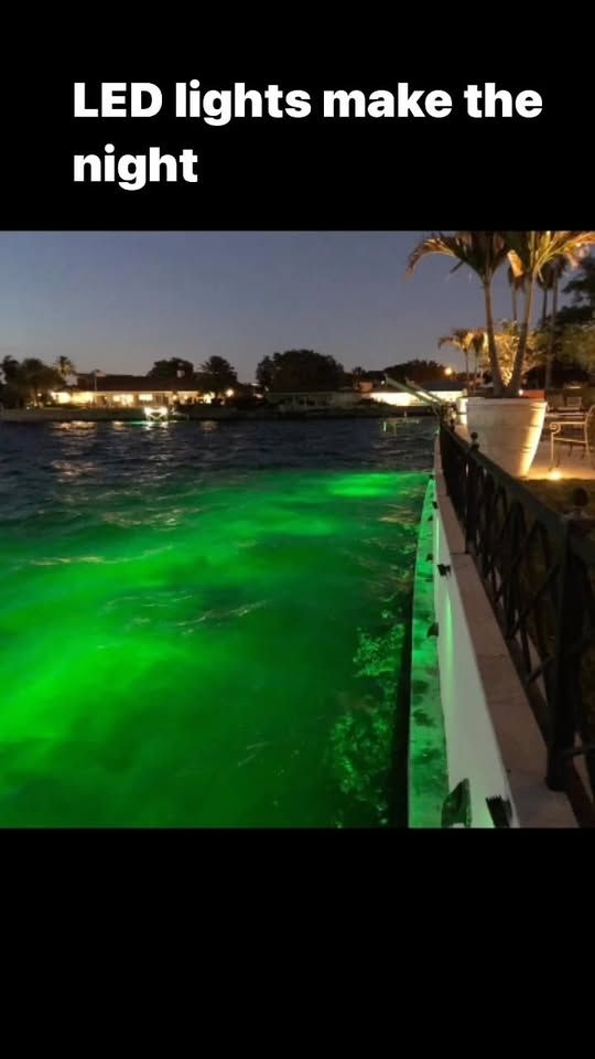 Waterfront dock with green LED underwater lighting at night