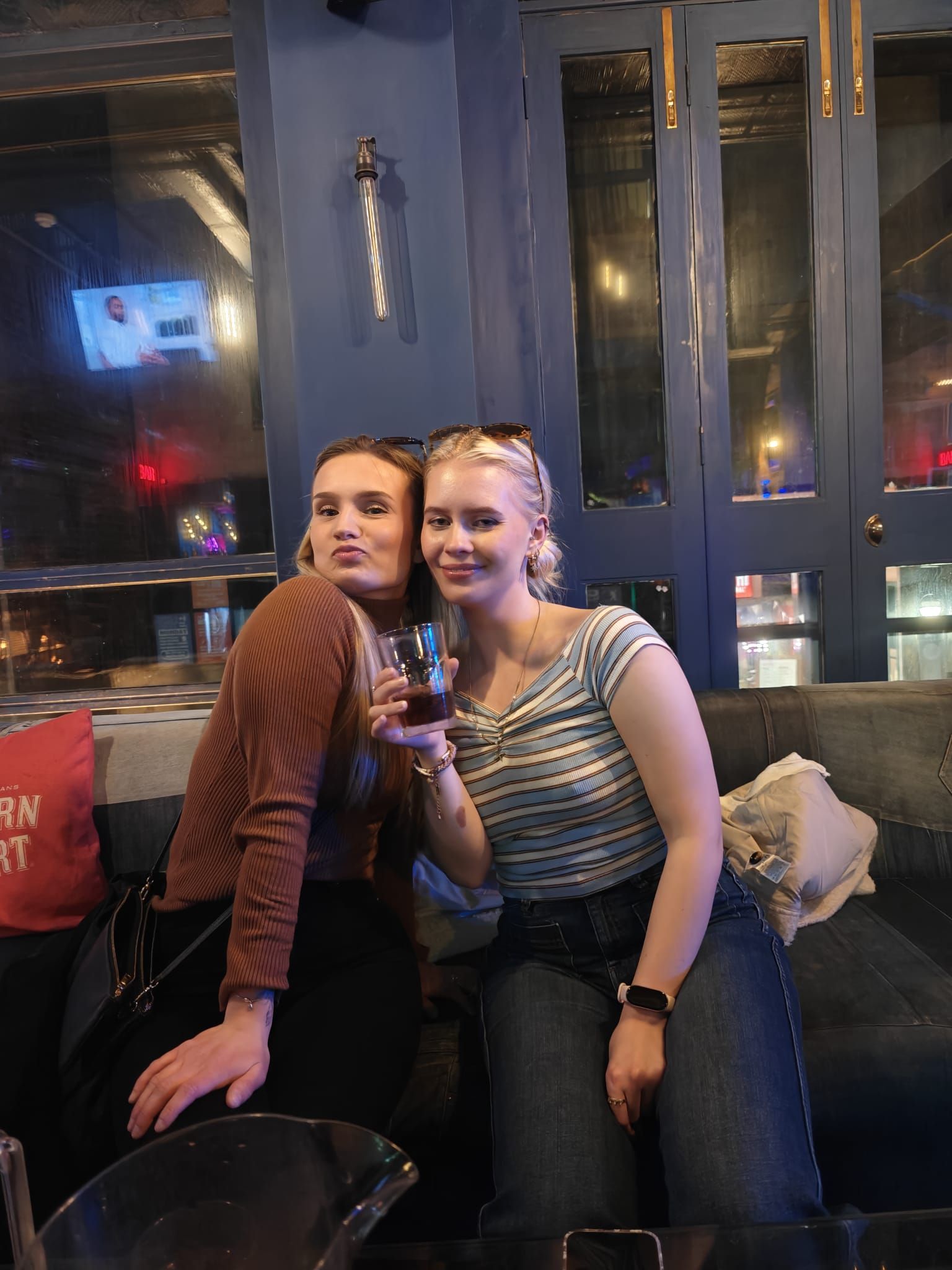 Two friends relaxing on a couch during a break on the Ebrius guided Glasgow pub crawl