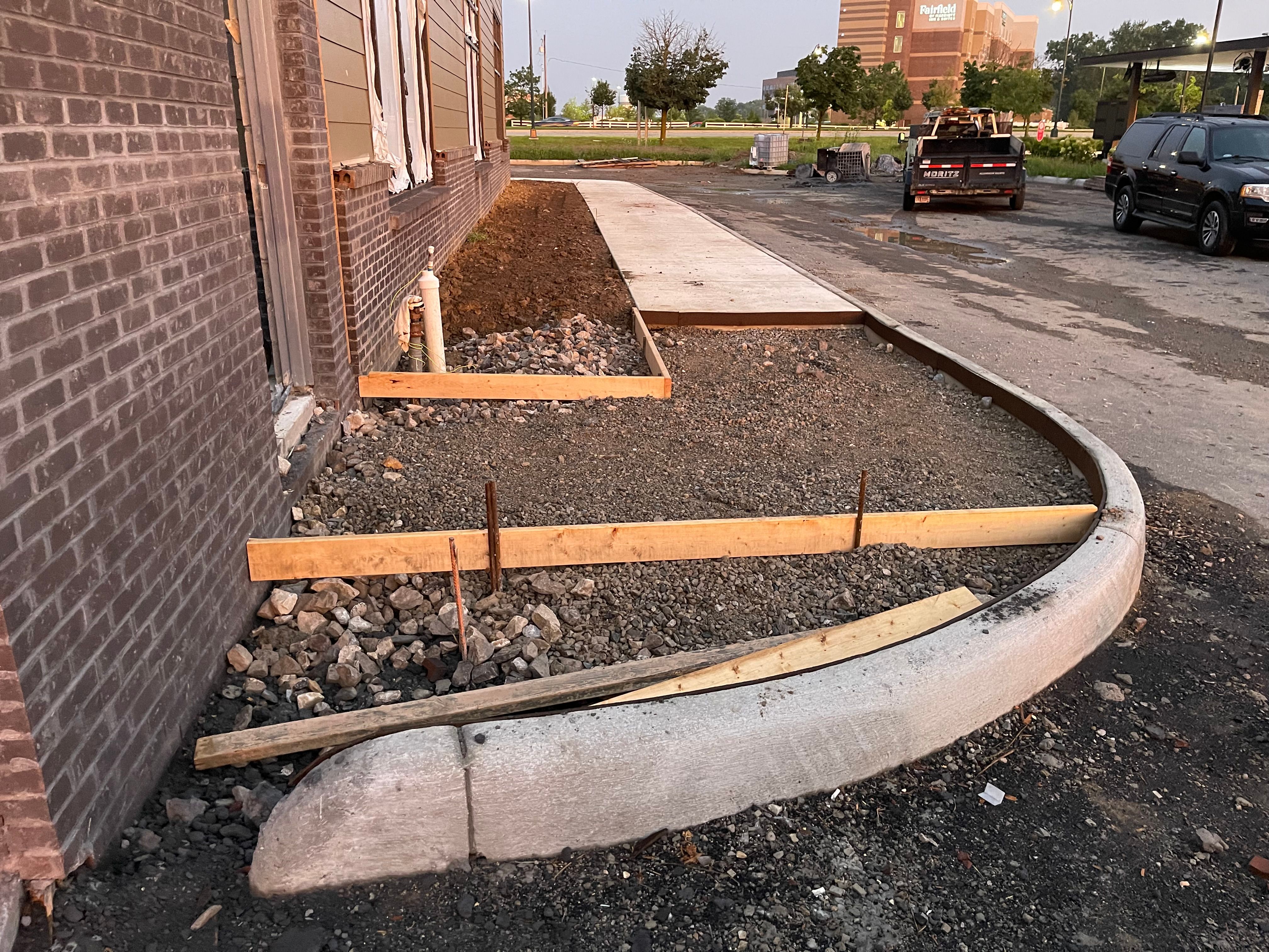 Sidewalk and curb concrete work along a building in Central Ohio