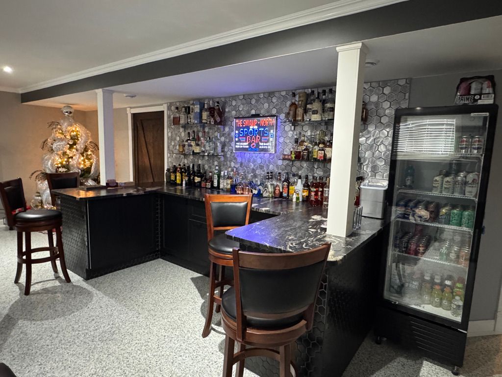 Residential basement bar with decorative speckle epoxy floor