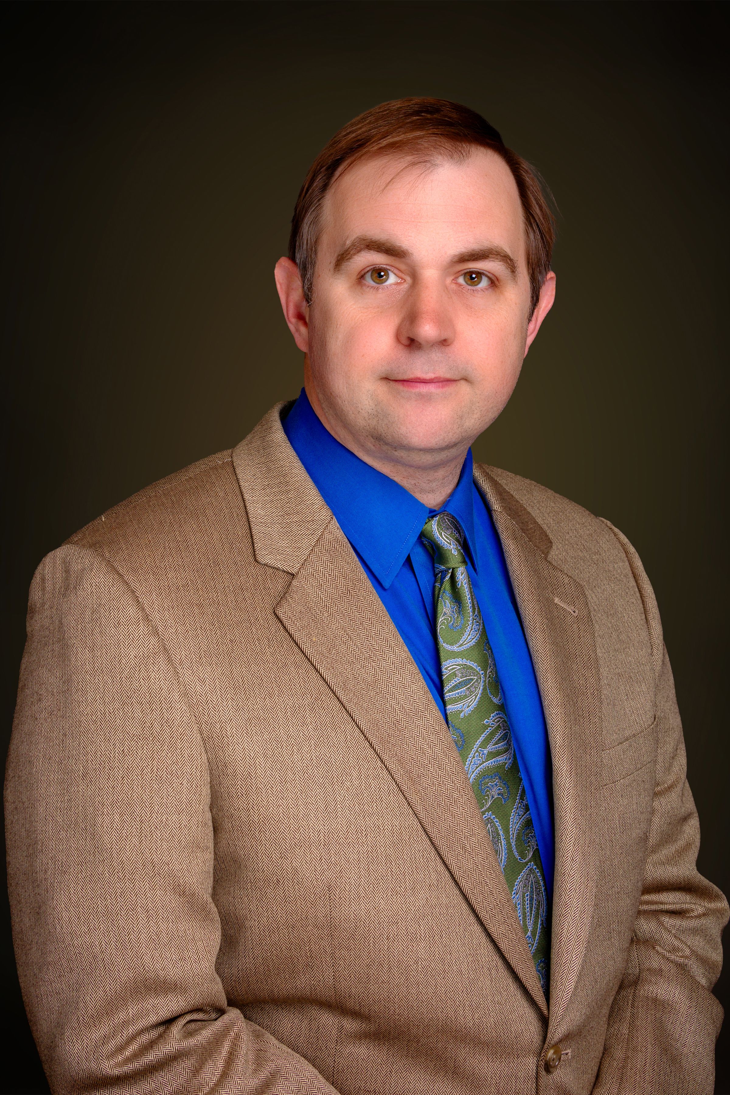 Professional headshot - man in tan suit