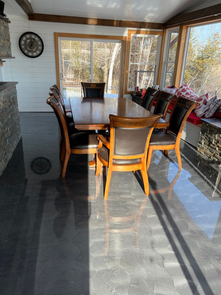 Residential dining room with dark charcoal metallic epoxy floor