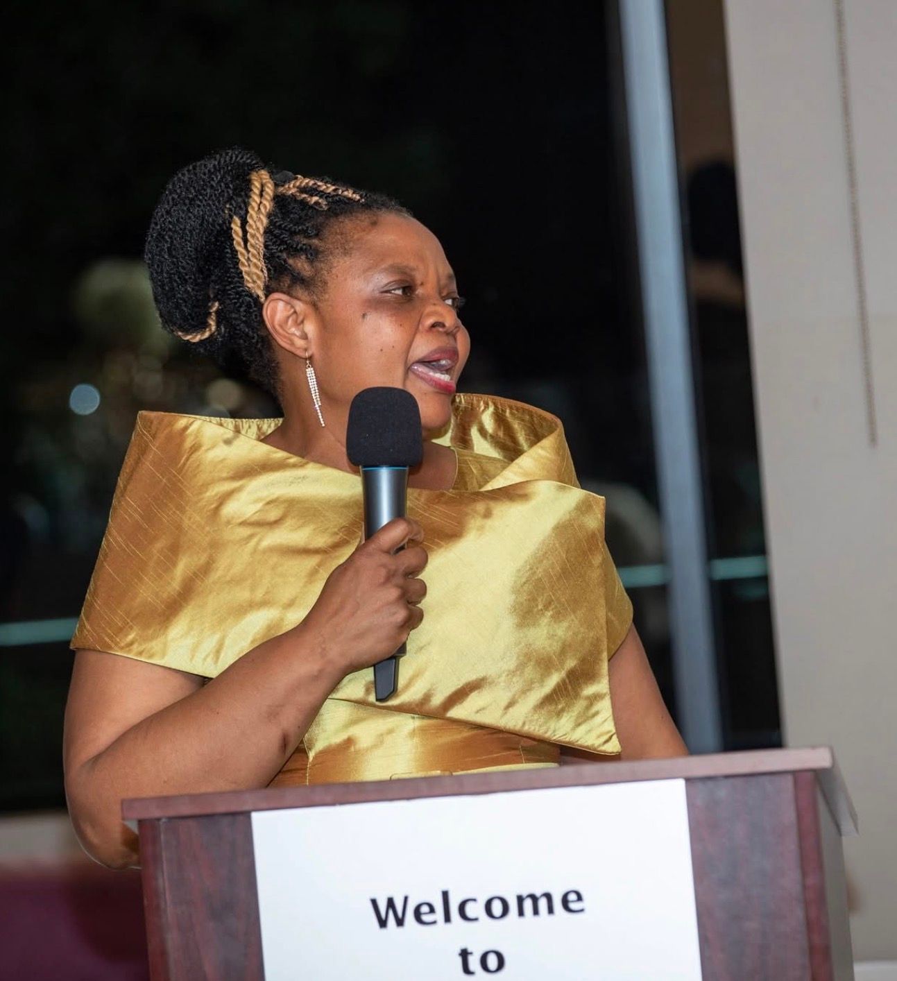 Miriam Muduwa speaking at a podium