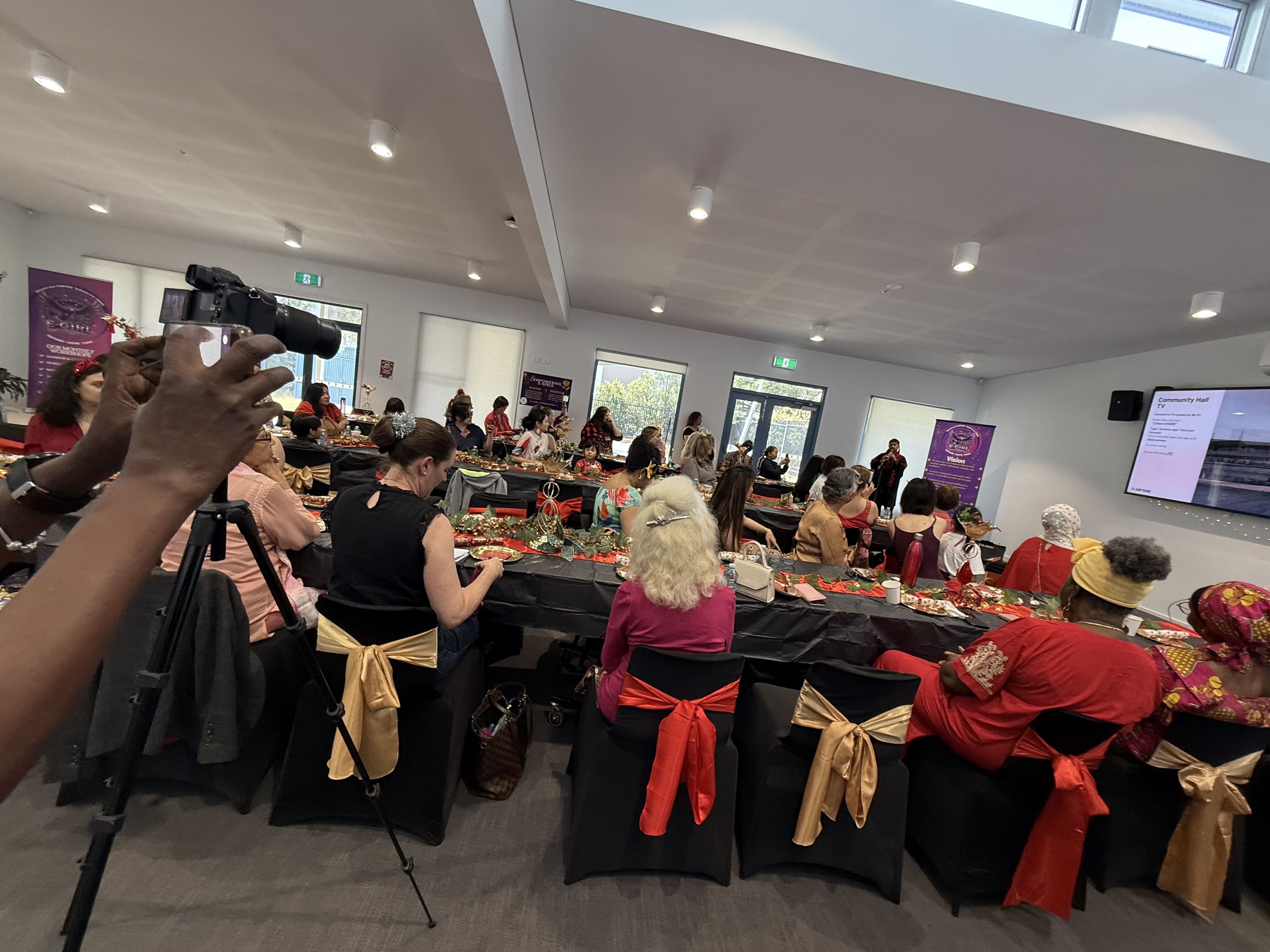 Full venue of women attending an E-Girl Empowerment event with beautifully decorated tables