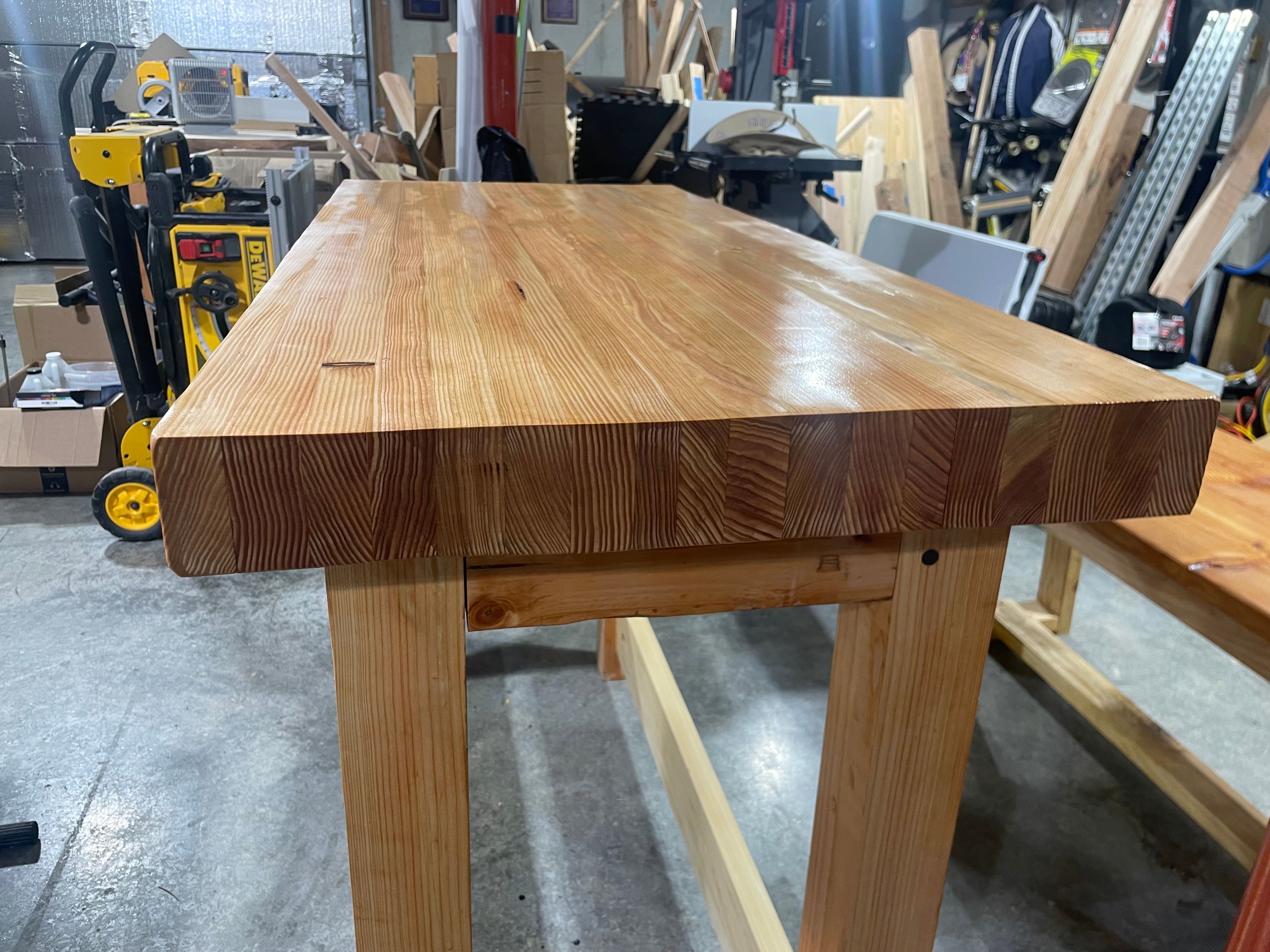 Polished workbench top showing smooth wood grain in workshop