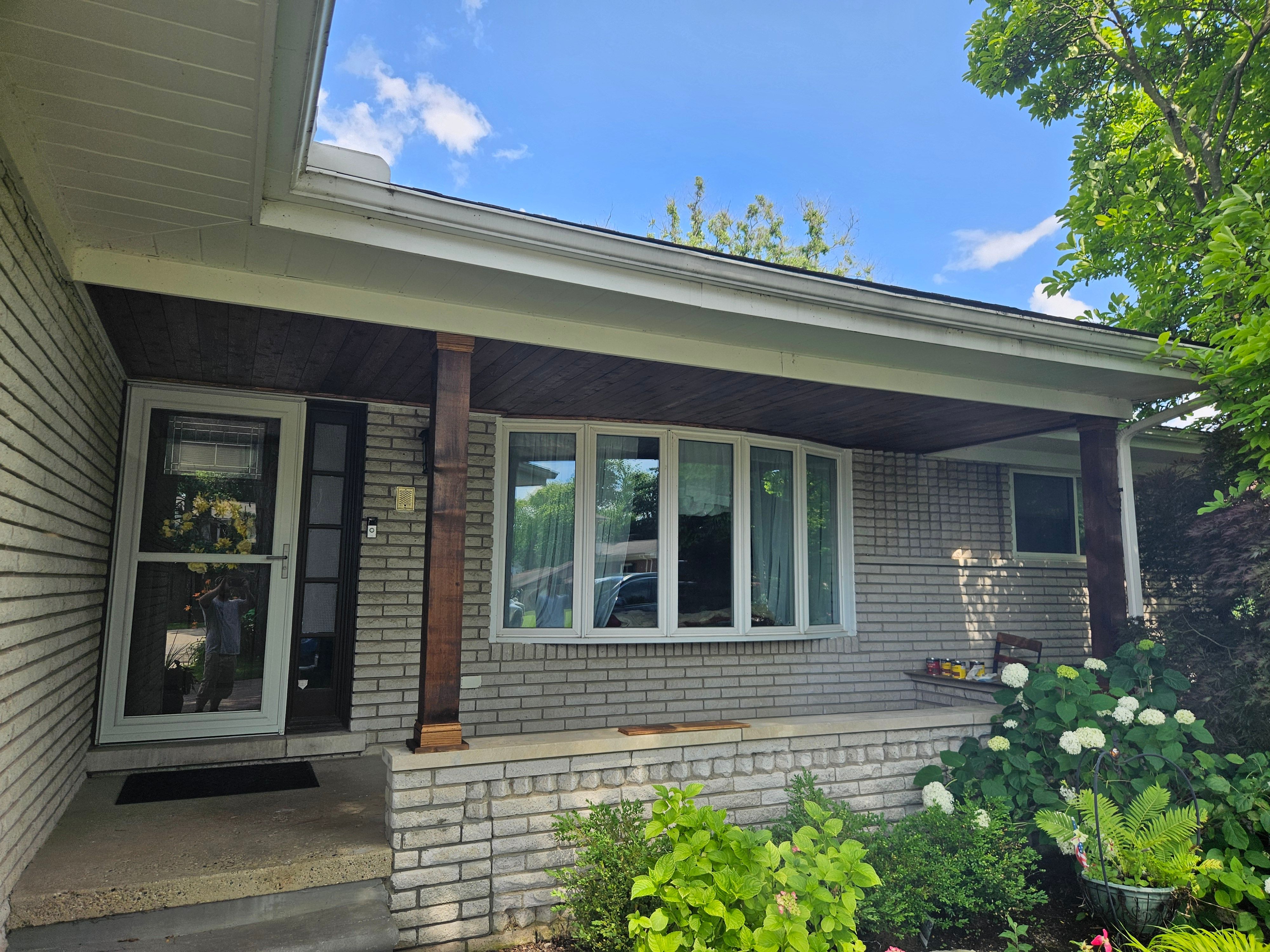 Front porch renovation with new pillars and decking