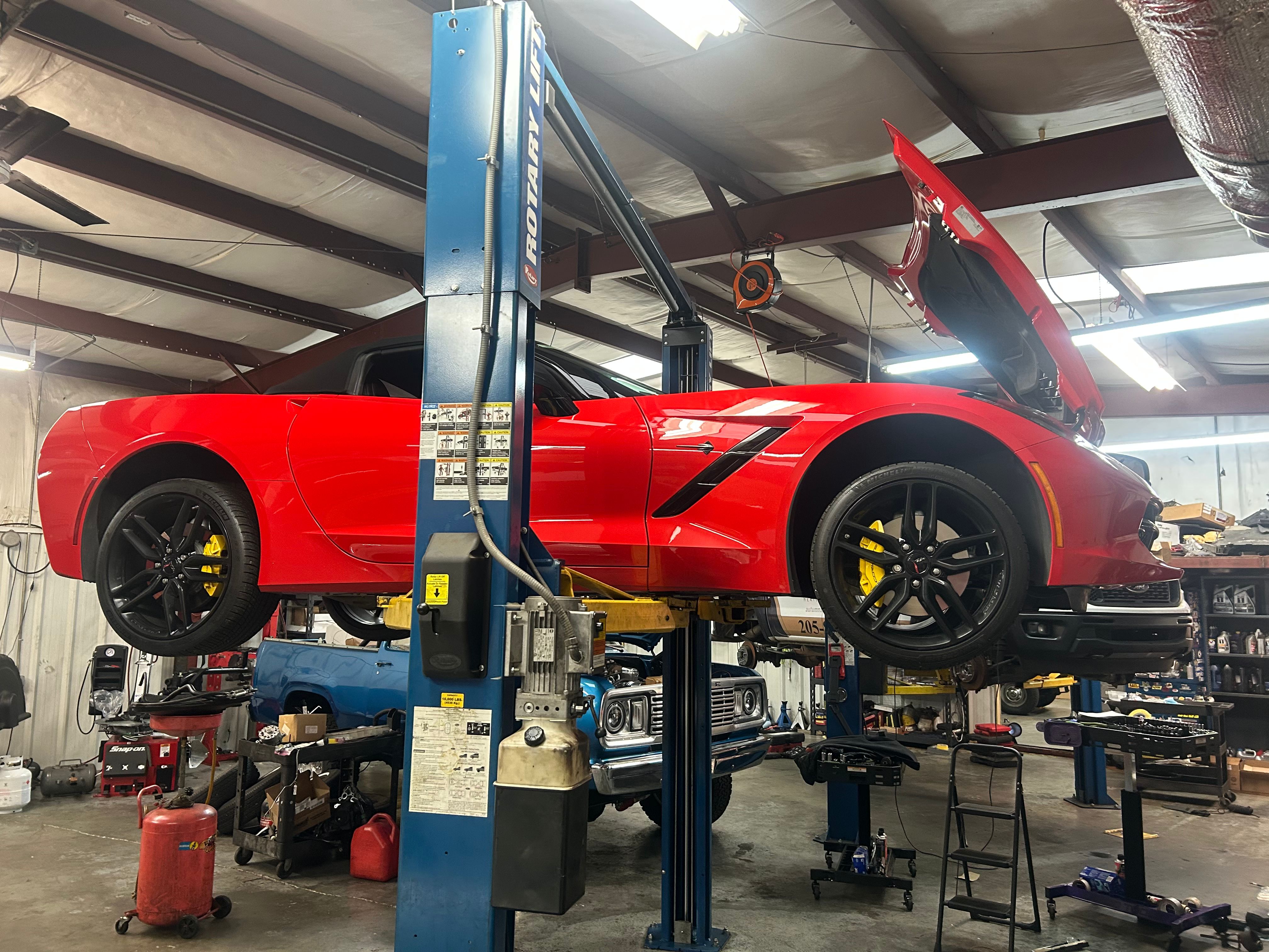 Red sports car on lift