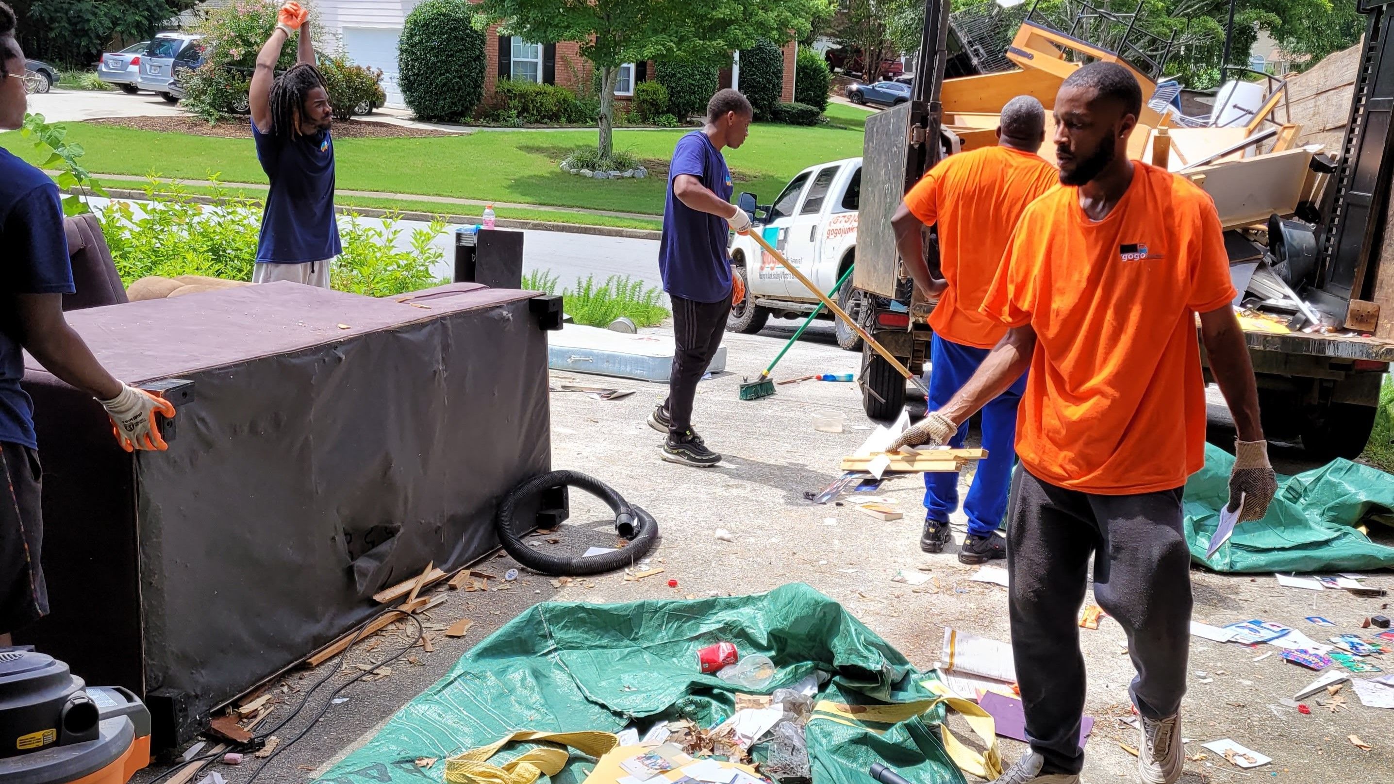 Team working on cleanout - GoGo Junk Removal technicians handling estate cleanout and property trash-out service