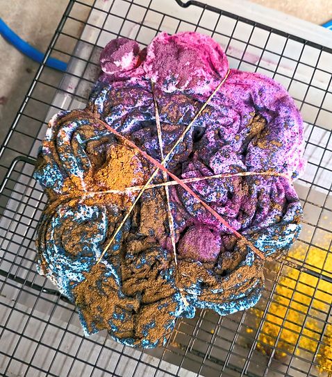 Tie-dye in progress on drying rack