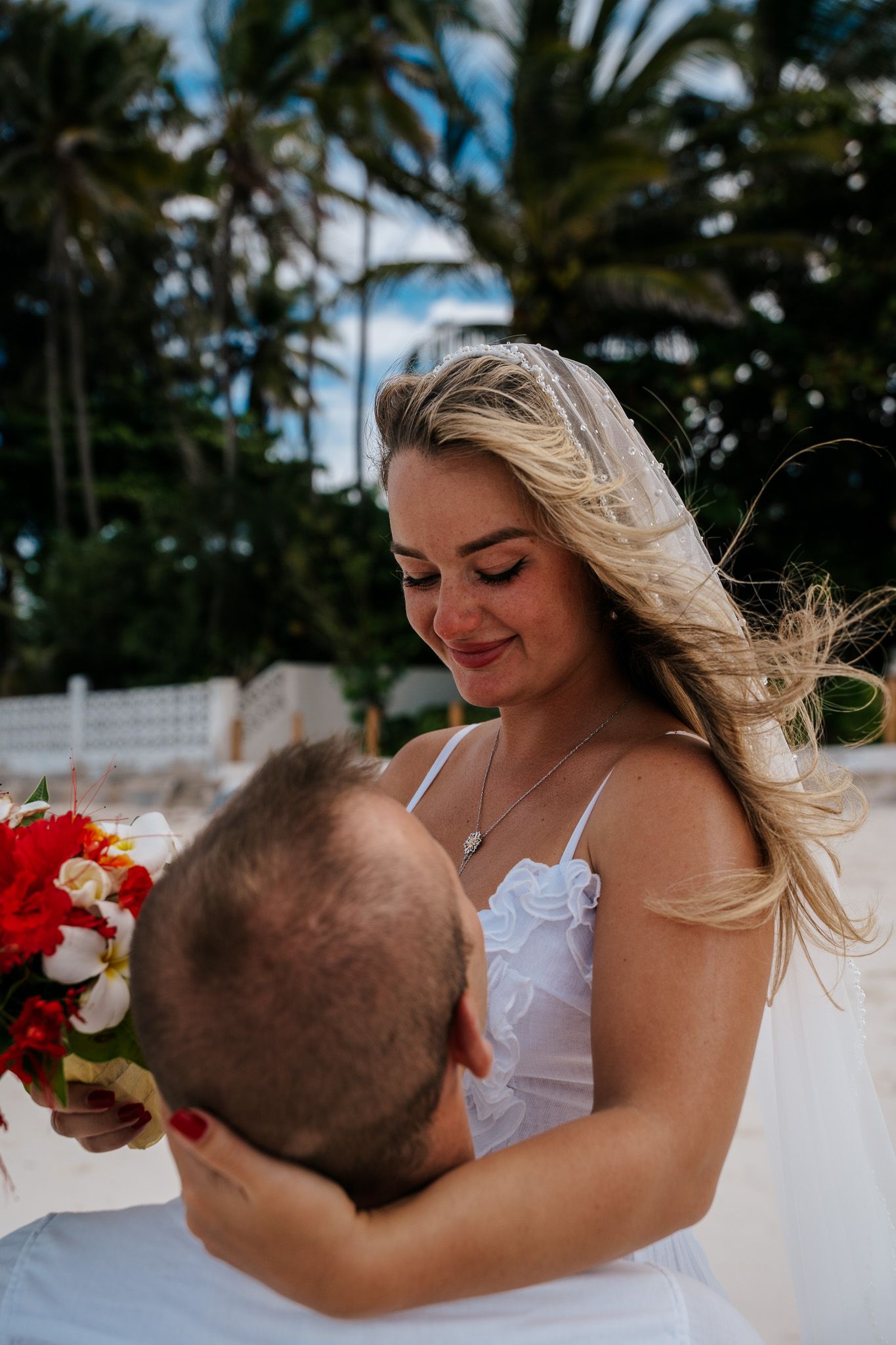 Bride with bouquet at beach wedding Zanzibar