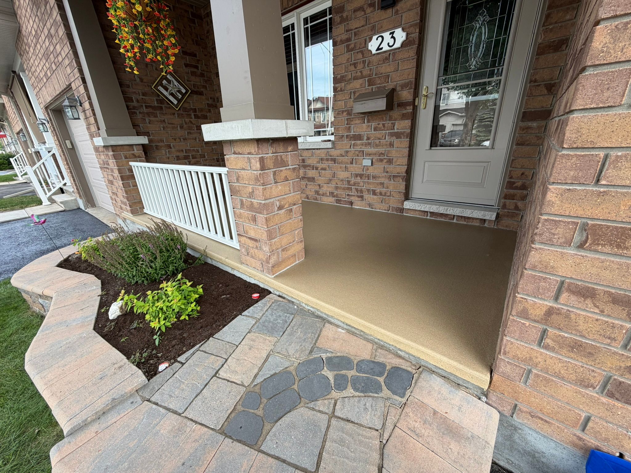 Residential front porch with light tan polymer coating — house #23