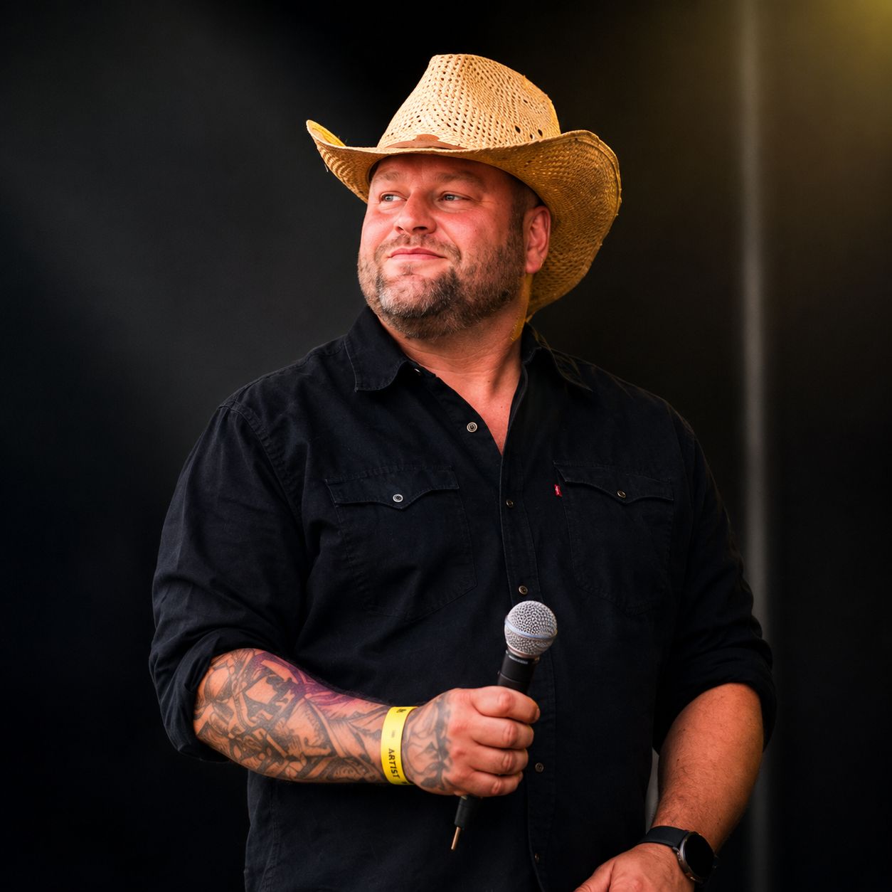 Close-up portrait of WAGGA with cowboy hat and artist wristband