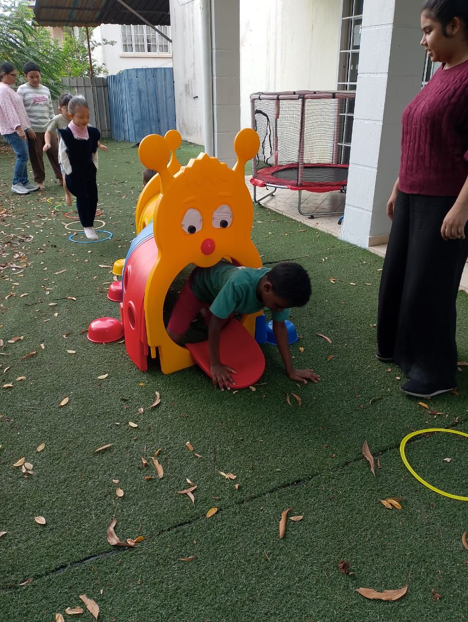 Children playing through caterpillar tunnel