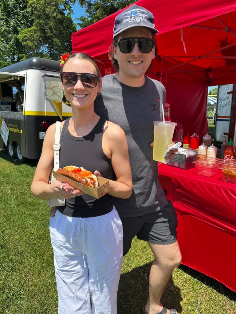 Couple enjoying hot dogs and lemonade