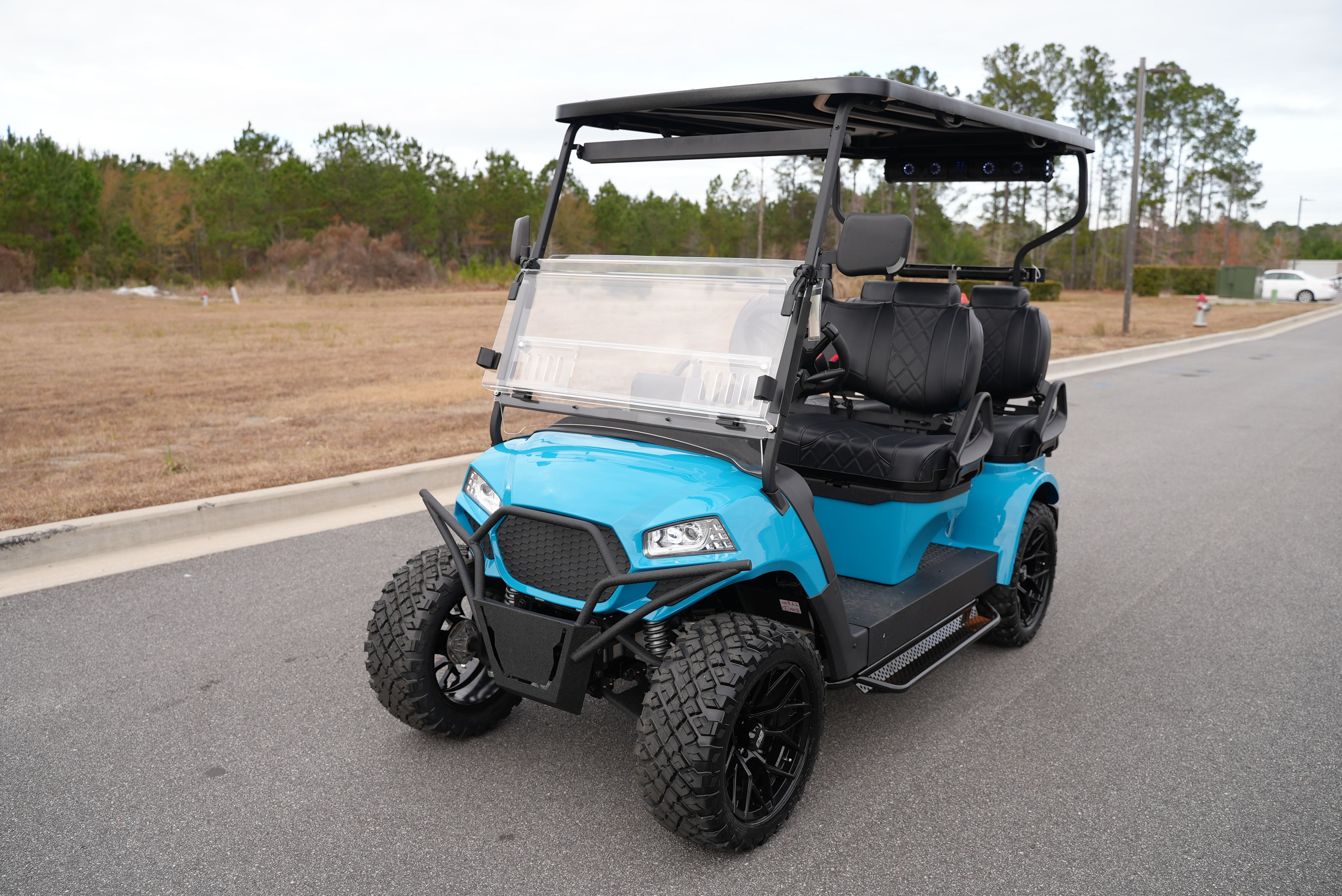 Blue electric golf cart at Hawg's Golf Cart dealership
