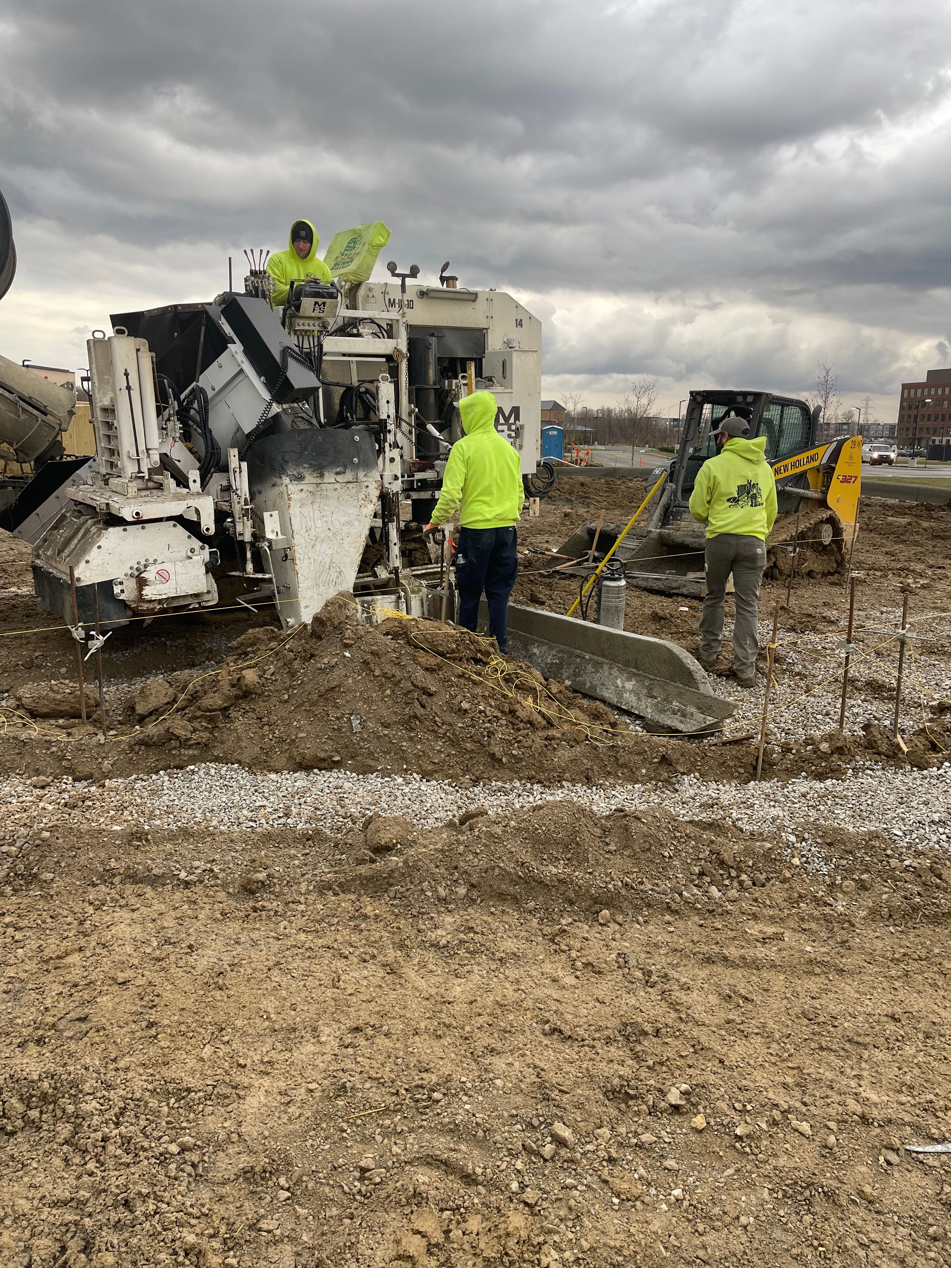 BURG CONCRETE crew operating curb machine on a commercial job site in Central Ohio