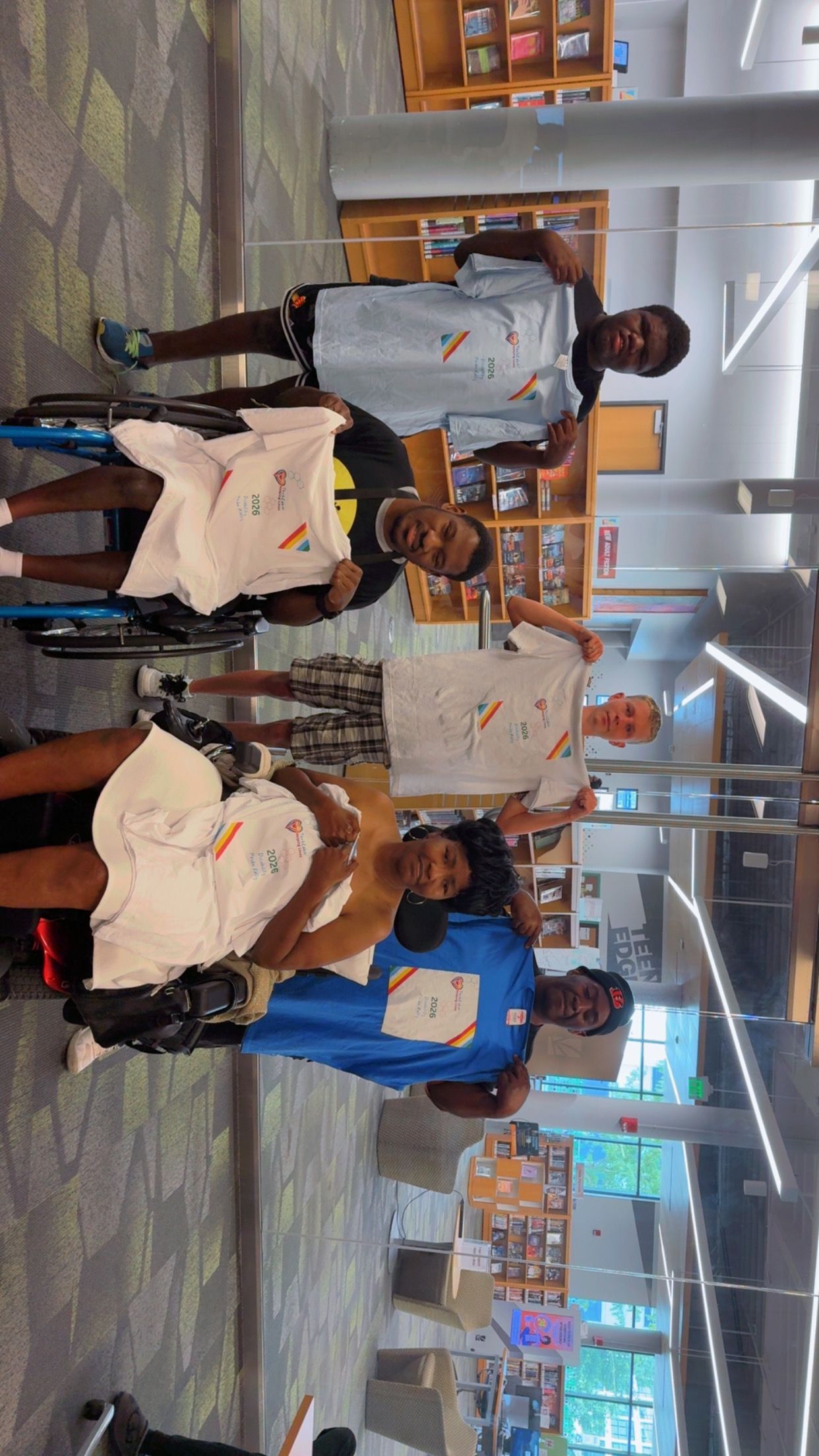 Helping Lives participants showing off Disability Pride Rally shirts
