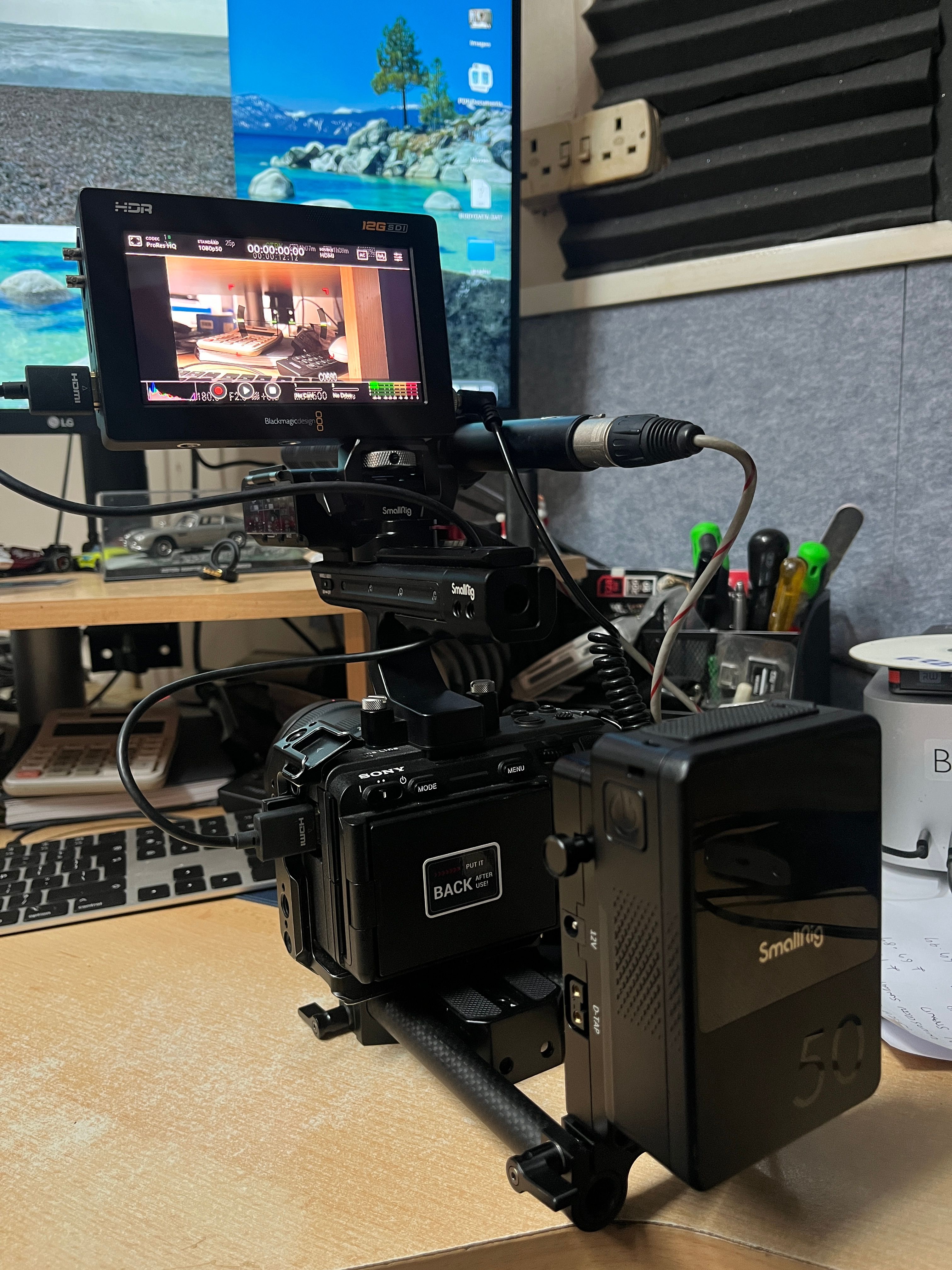 Sony camera with SmallRig cage and external monitor — professional video production setup