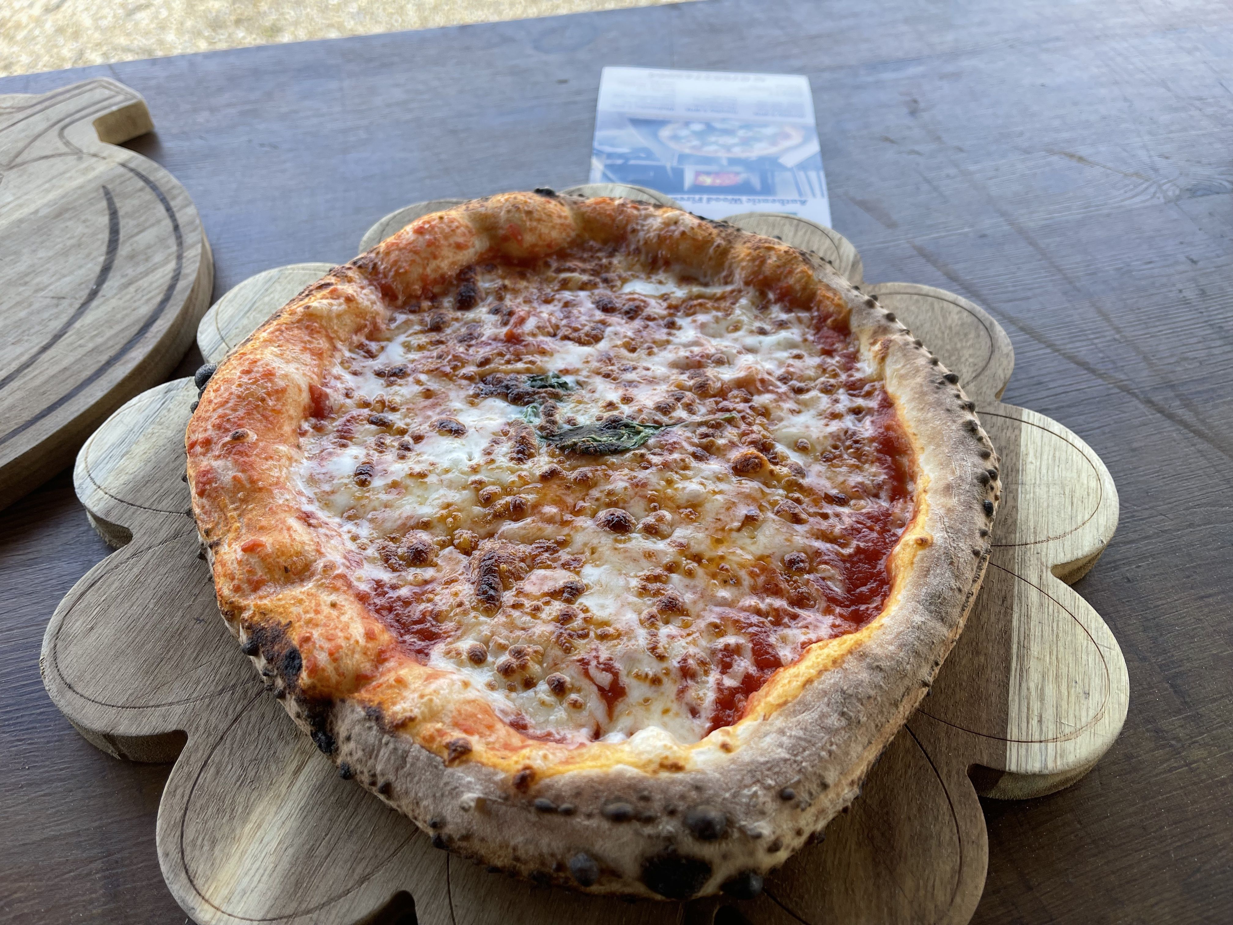 Margherita pizza on a wooden board at The Comet