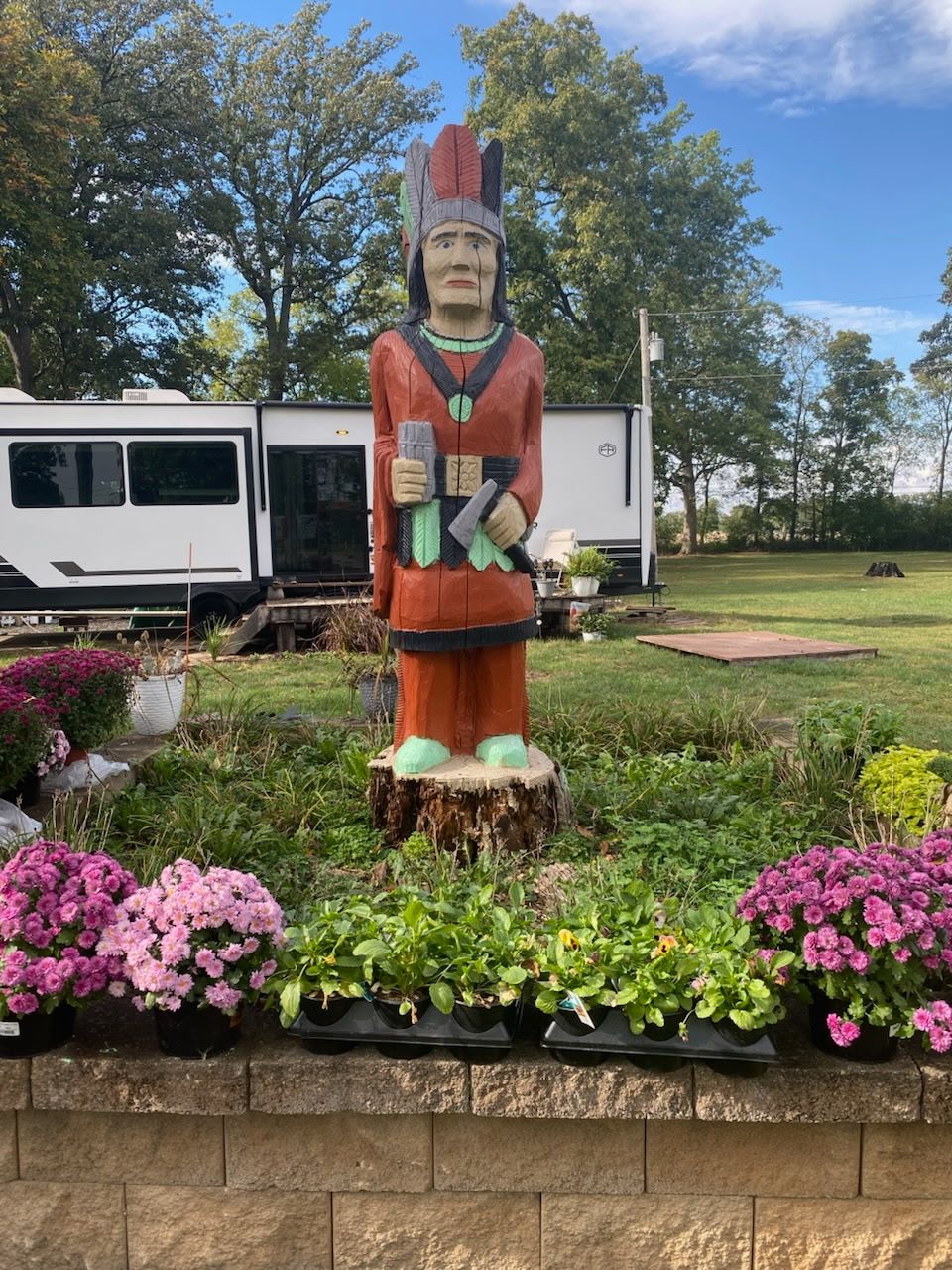 Carved wooden statue in garden at Welcome Woods RV Campground