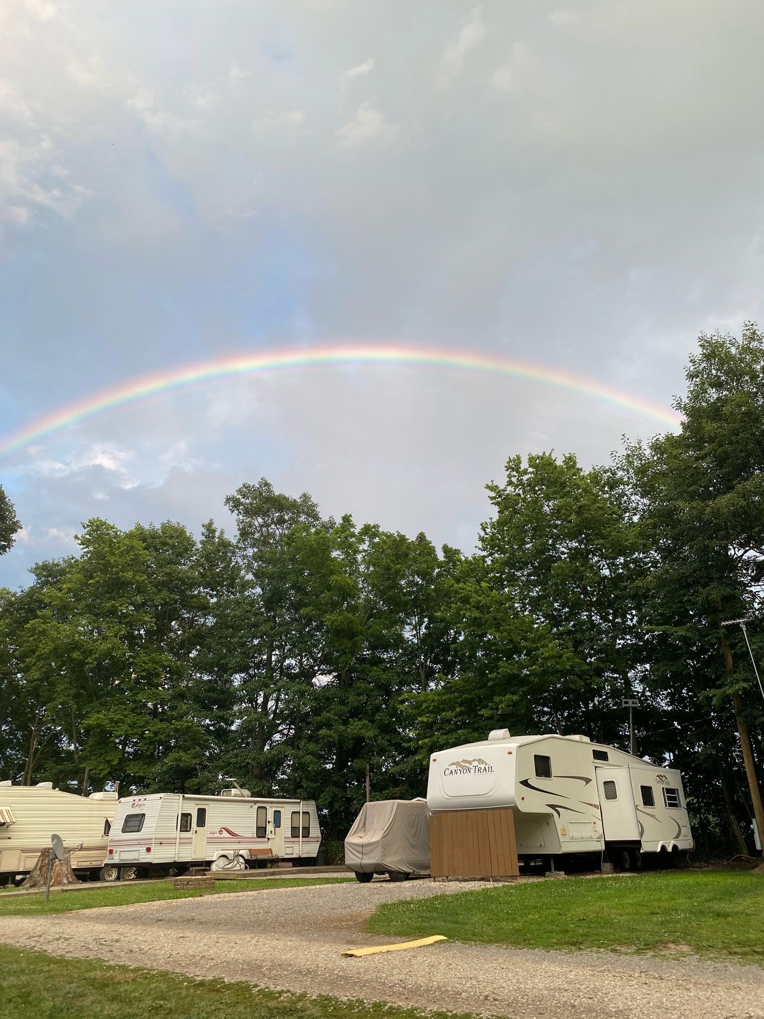 Rainbow over RV trailers at Welcome Woods campground near Indian Lake