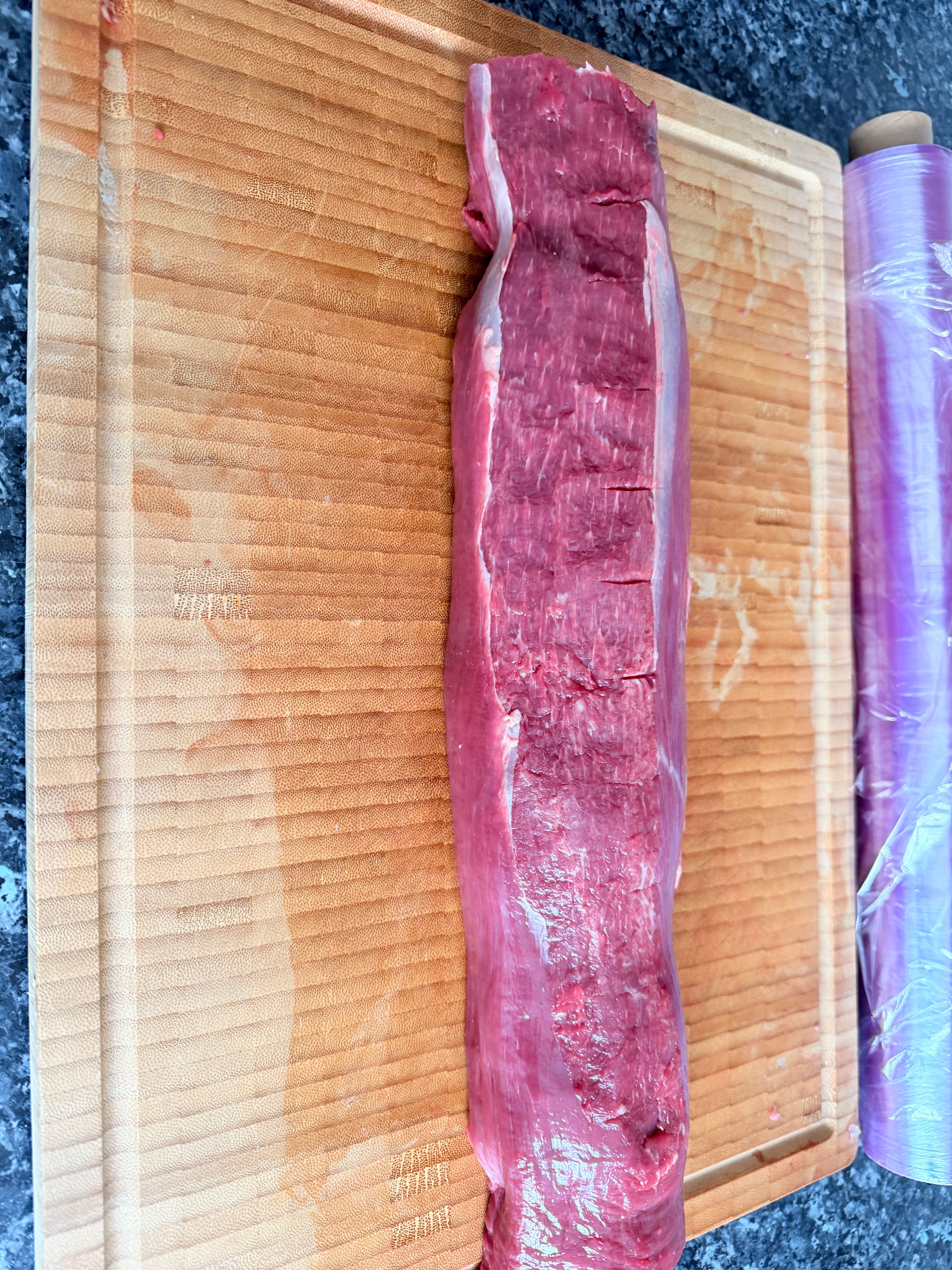 Premium beef tenderloin being prepared on the board