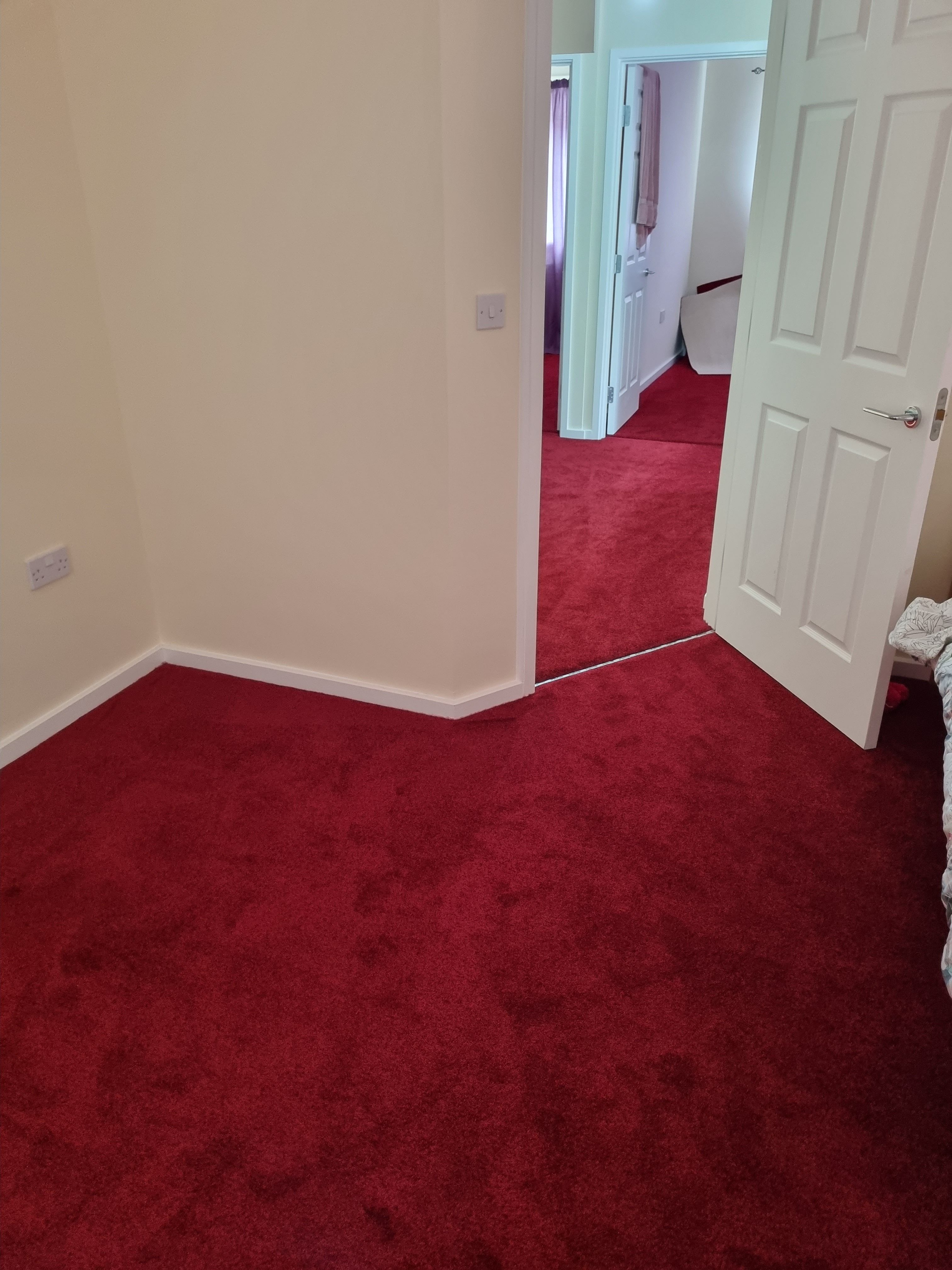 Bright red carpet fitted in bedroom and hallway
