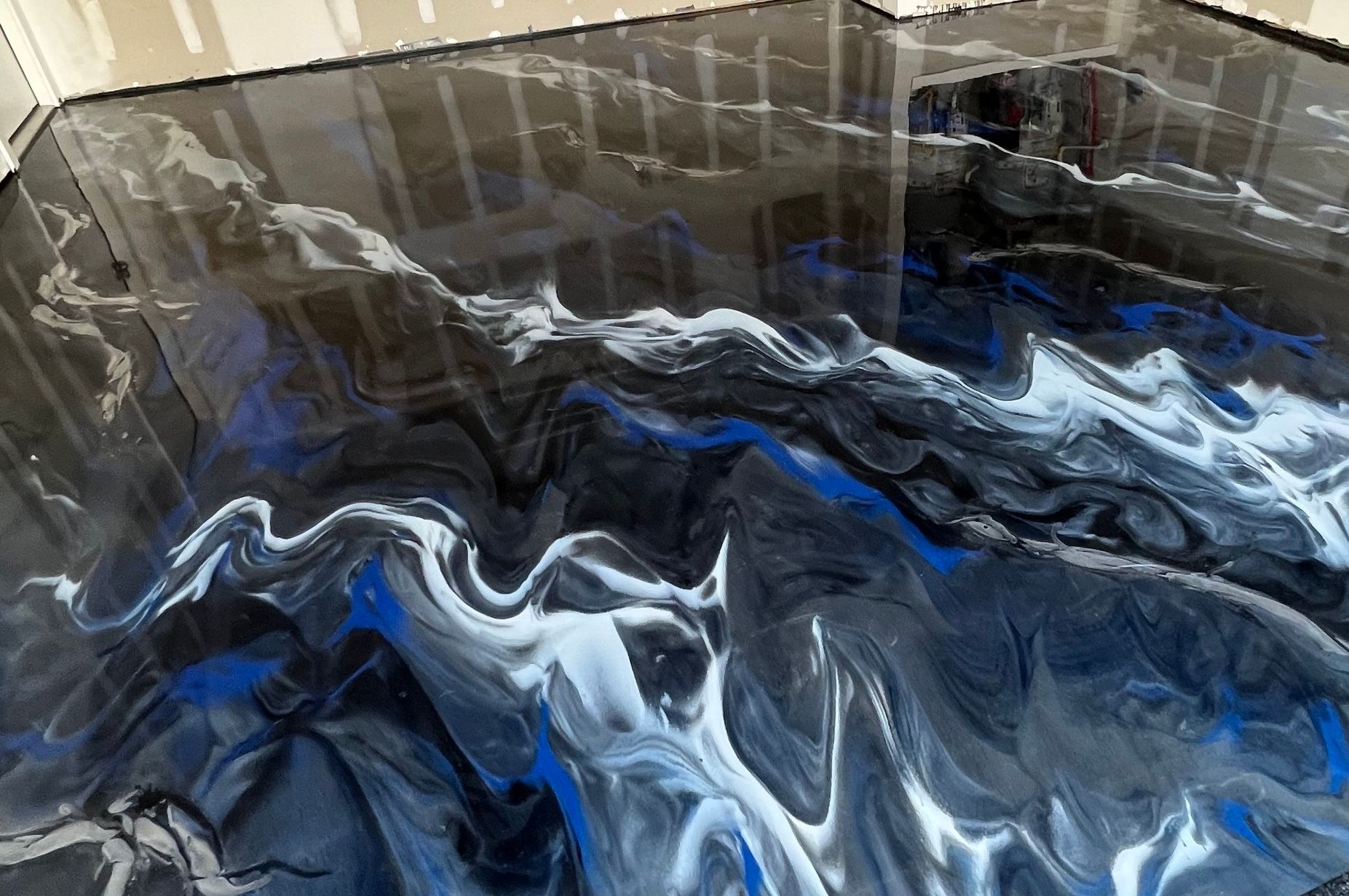 Abstract marbled epoxy floor in black, white and blue — custom 1-of-1 design