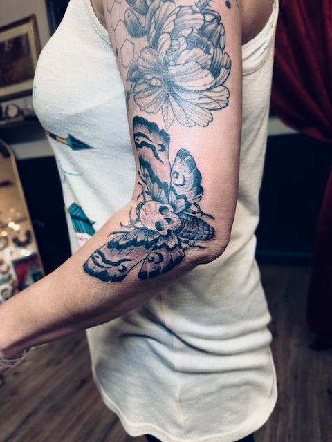 Black and grey tattoo by Justin - butterfly with skull centerpiece
