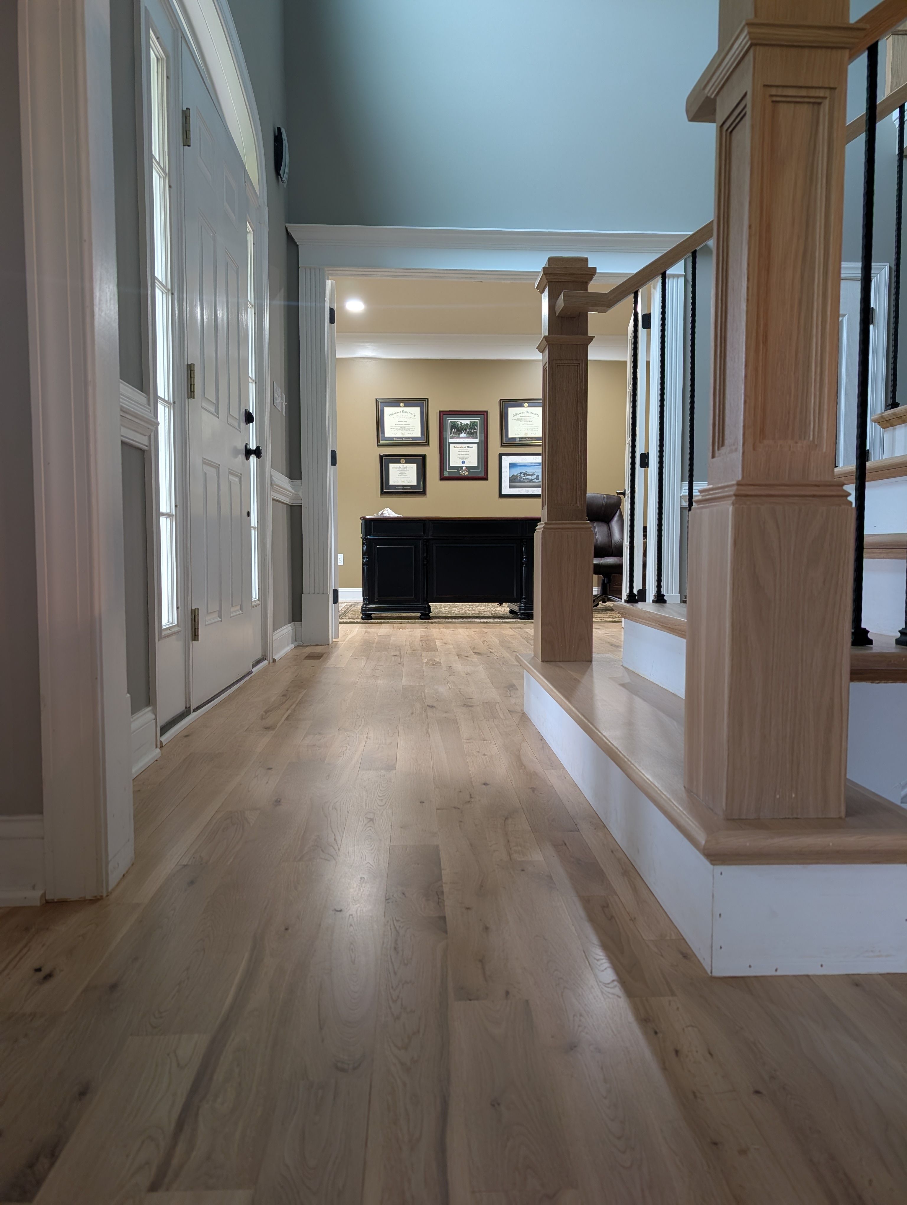 Hallway with hardwood and staircase