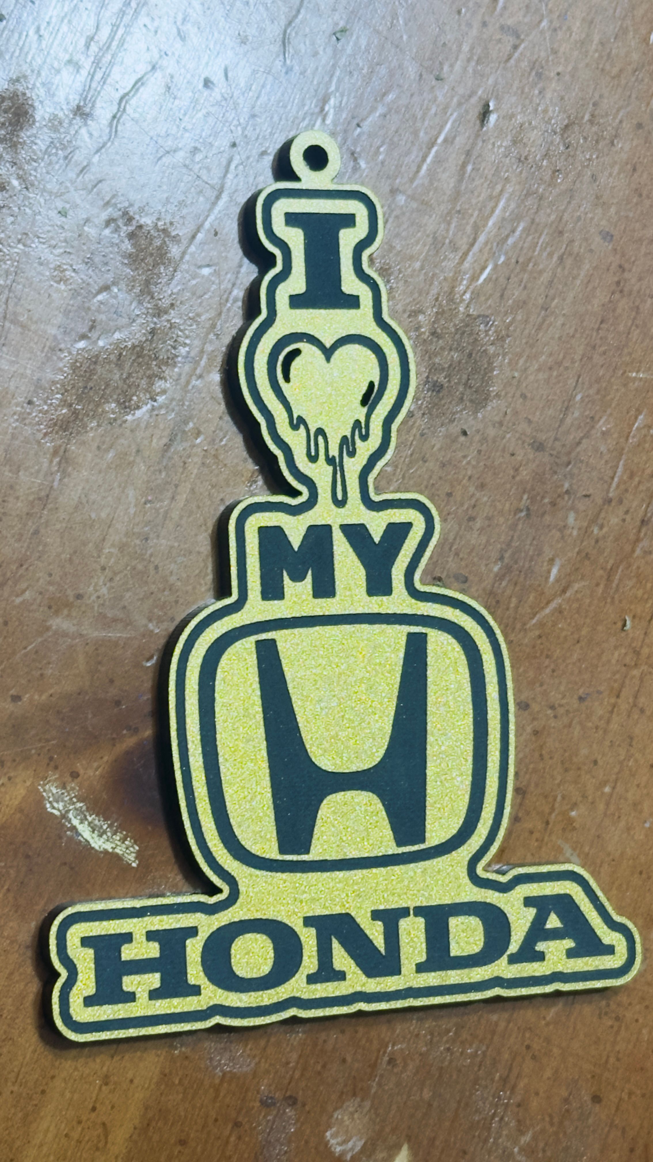Yellow and black laser-cut keychain with I heart my Honda design