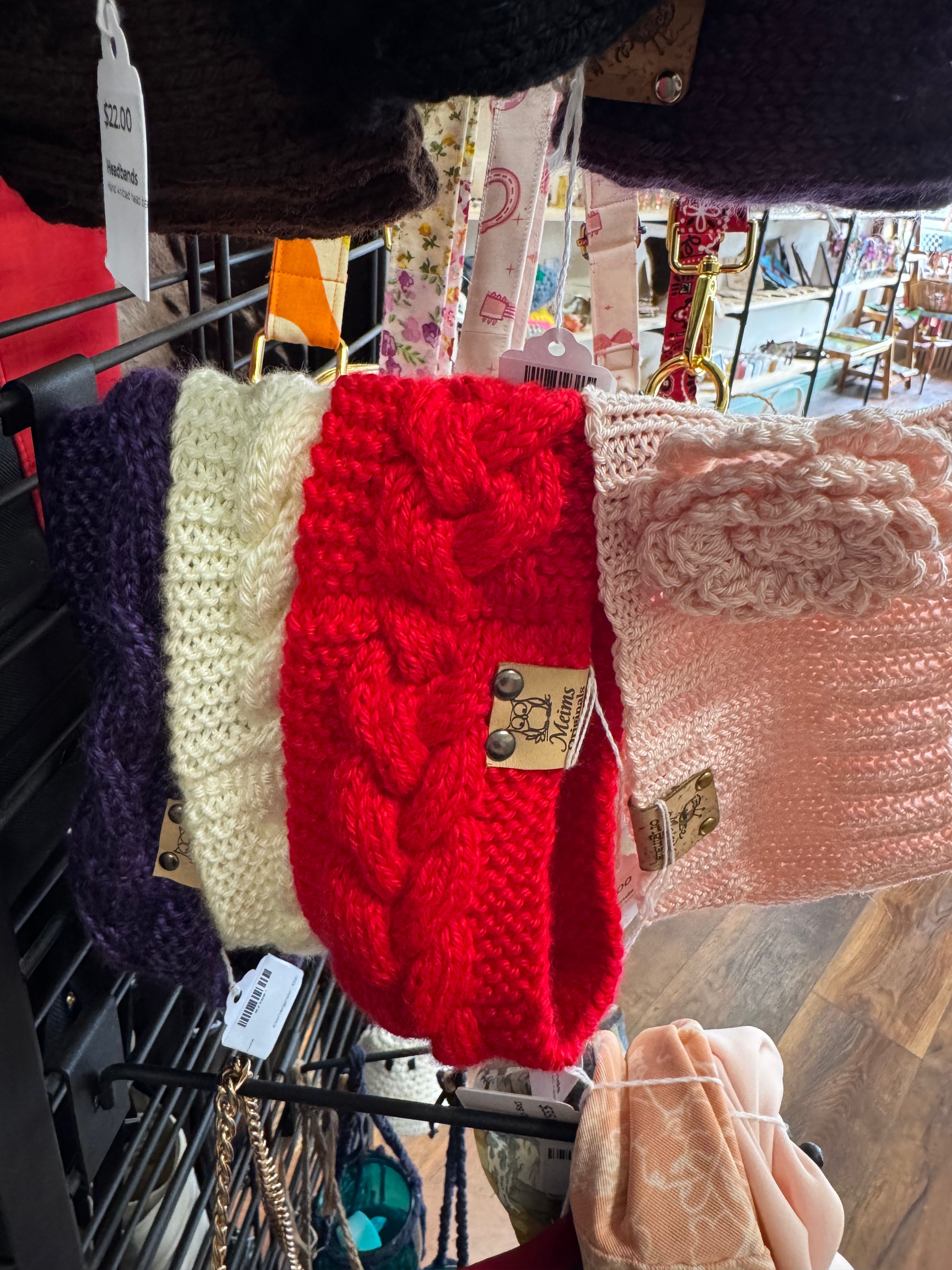 Meims knitted headbands on display rack