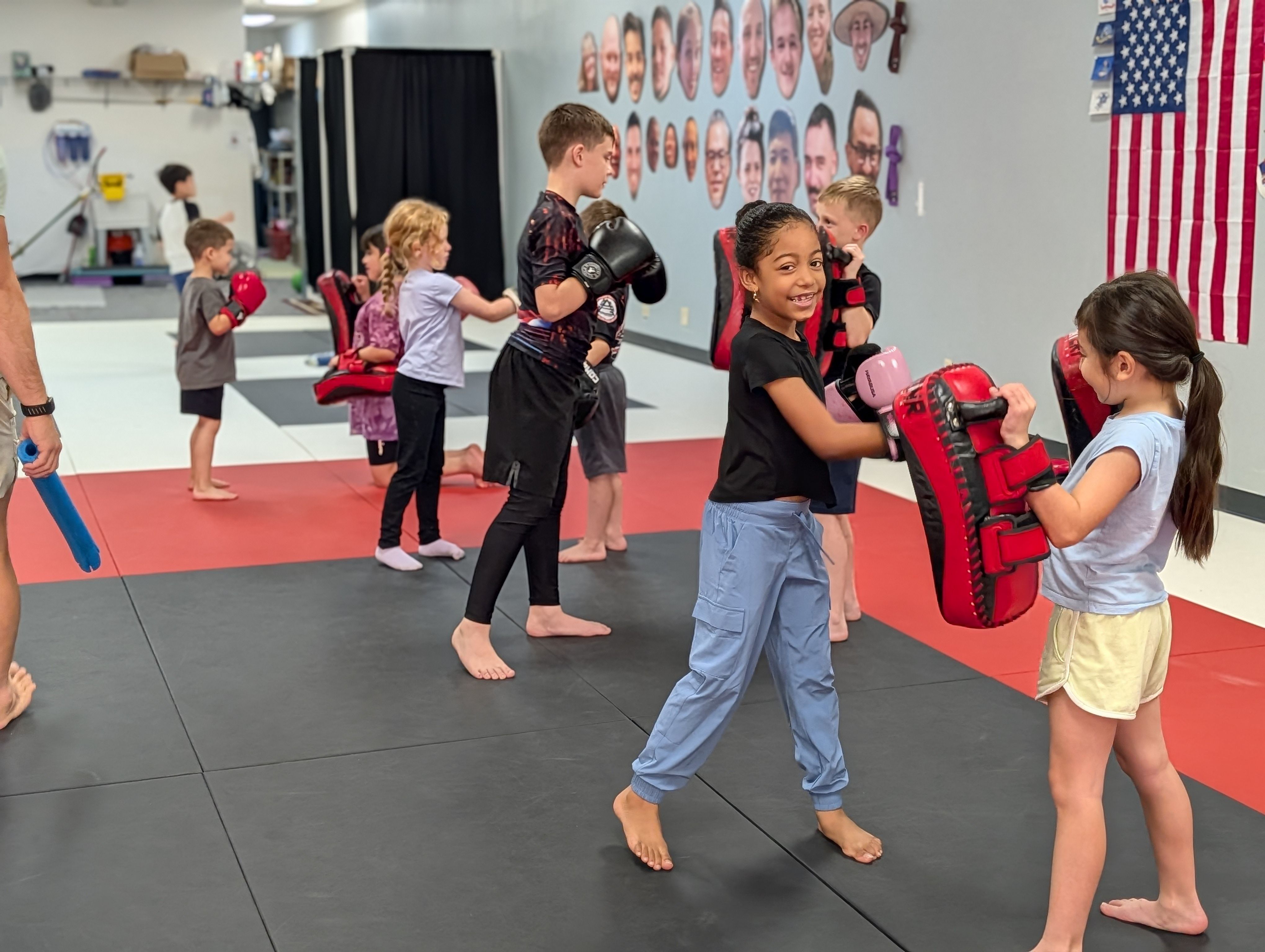 Kids practicing kickboxing drills at Aura Jiu Jitsu