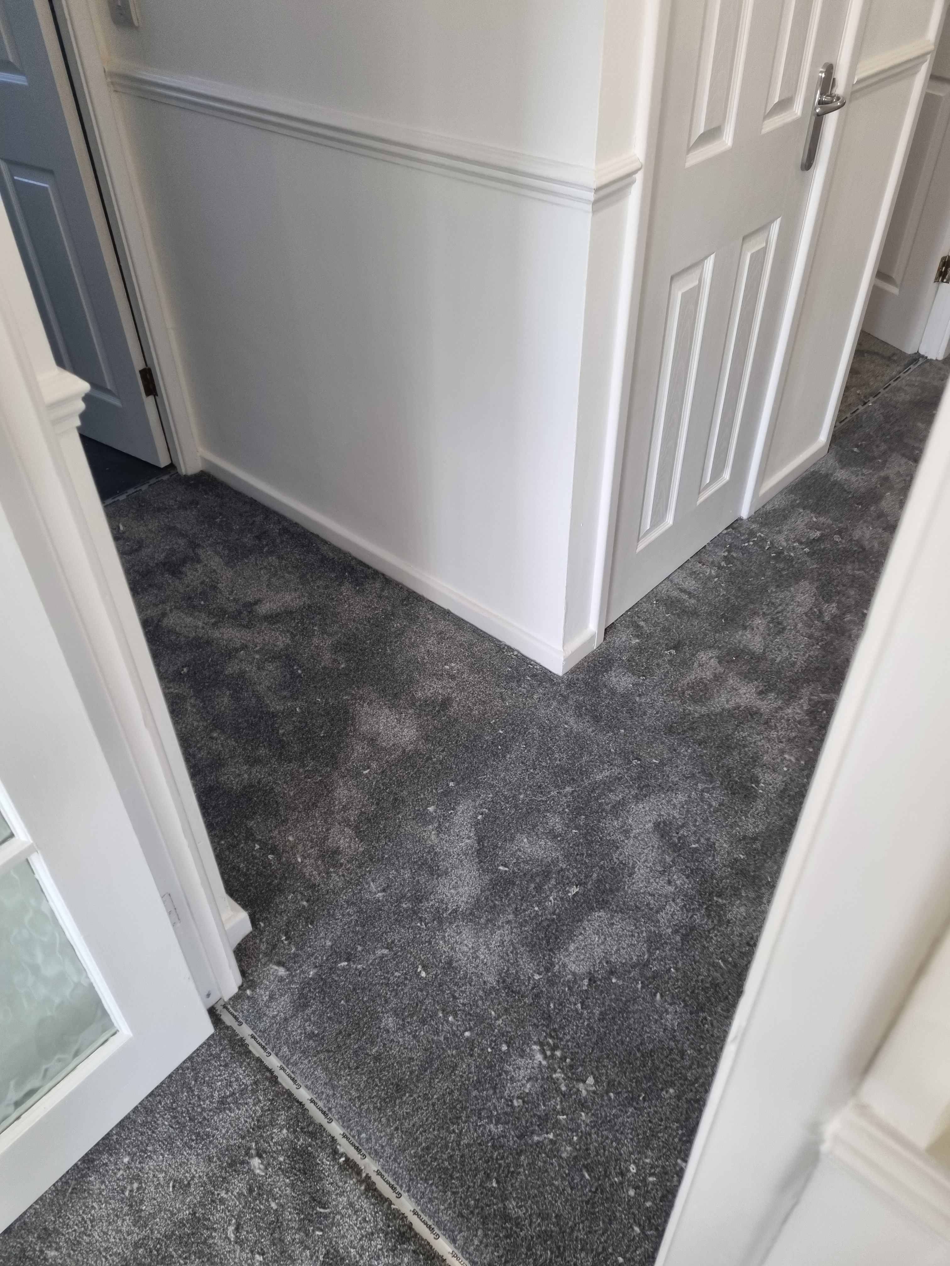 Grey carpet fitted in hallway with multiple rooms